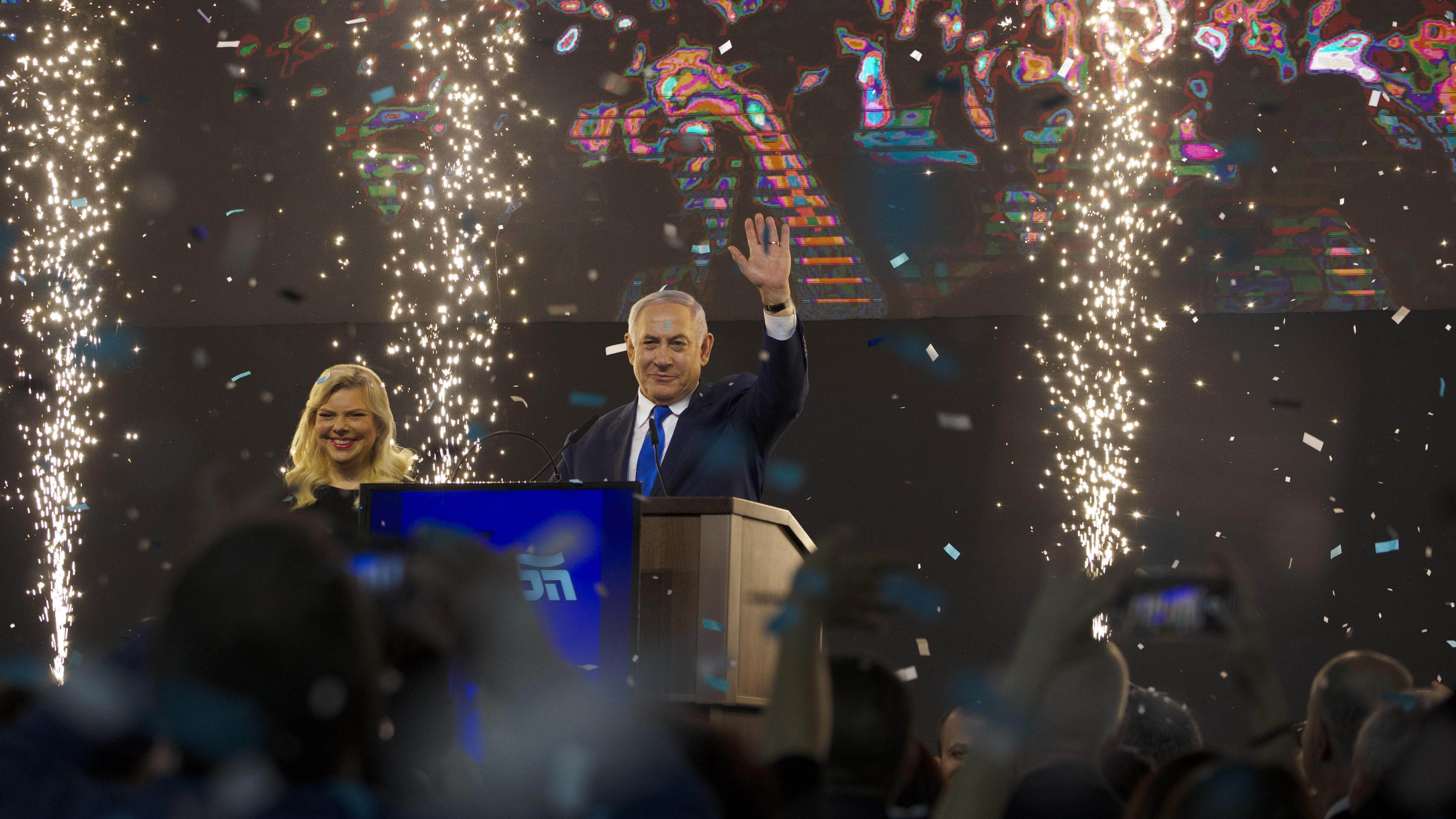 Israel's Prime Minister Benjamin Netanyahu accompanied by his wife Sara waves to his supporters after polls for Israel's general elections closed in Tel Aviv, Israel, Wednesday, April 10, 2019.