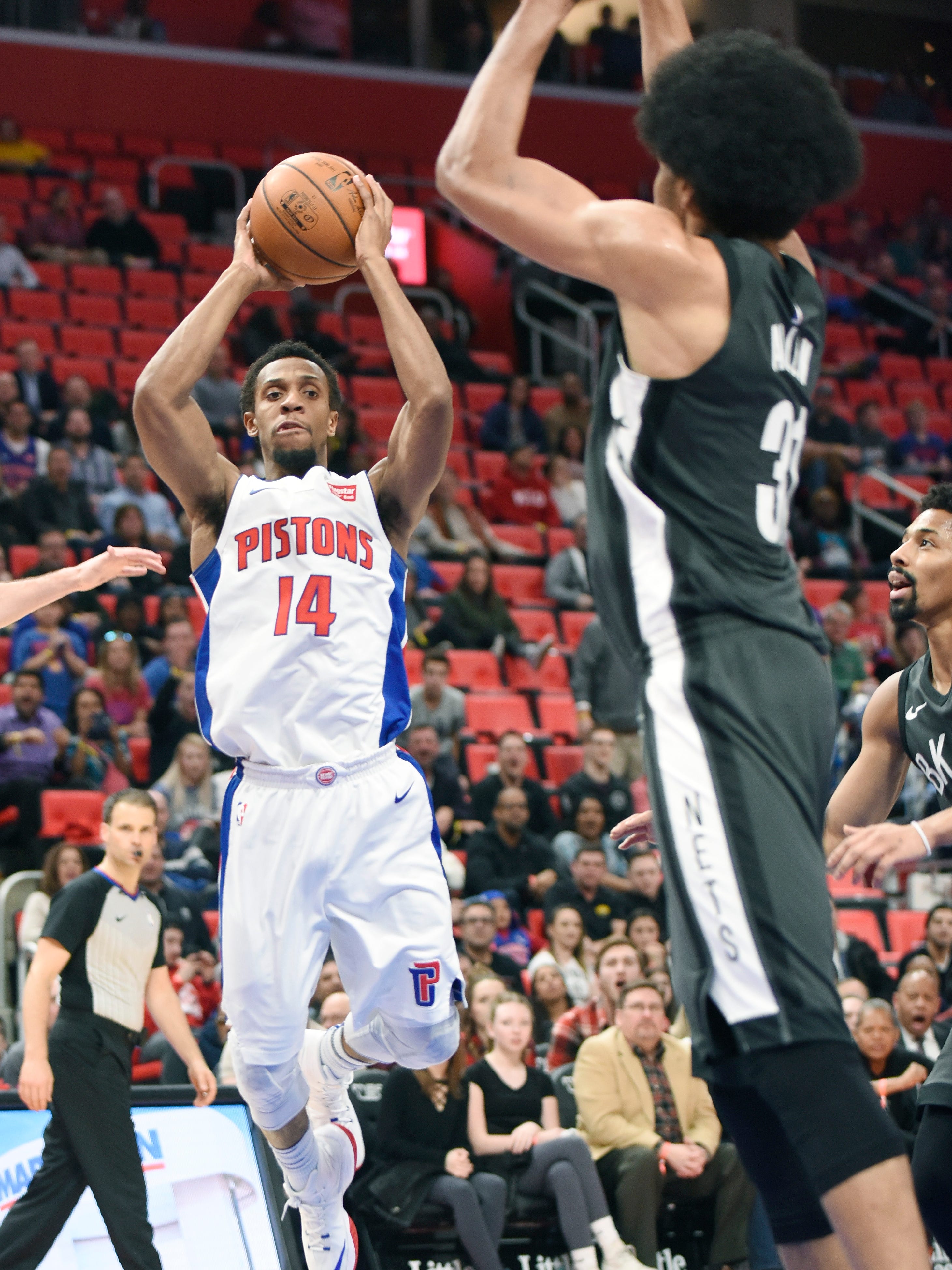 Pistons' Ish Smith looks to make a pass over Nets' Jarrett Allen in the fourth quarter.