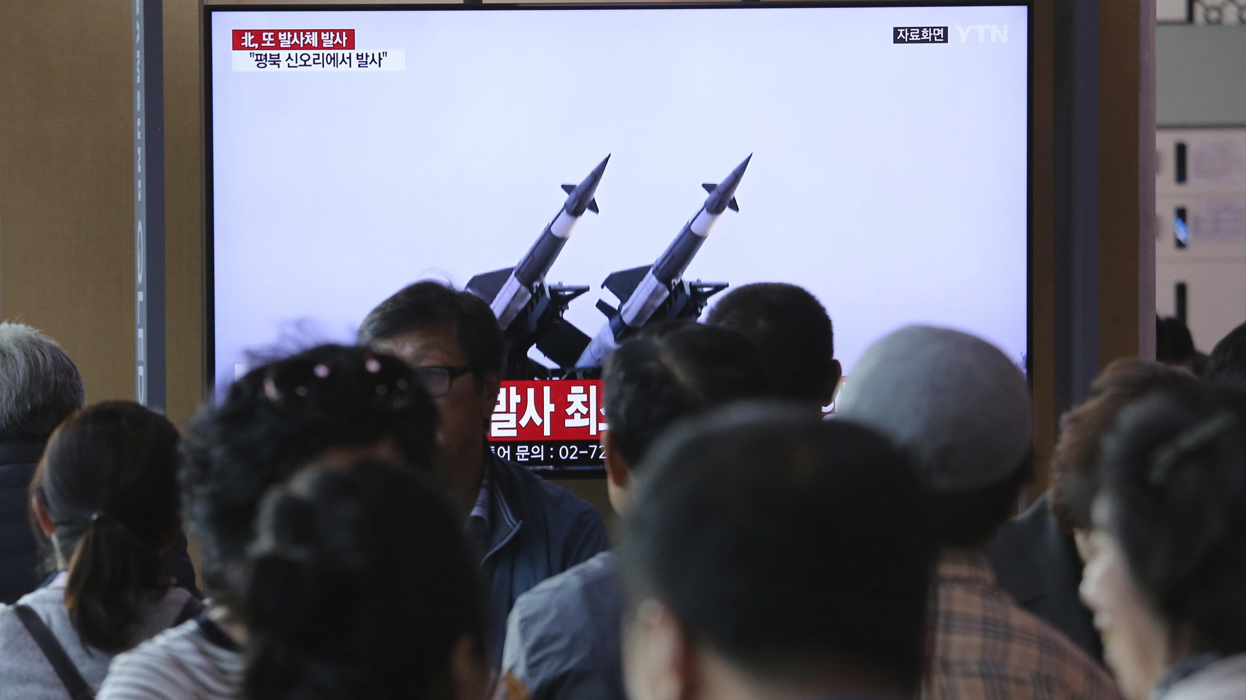 People watch TV showing file footage of North Korea's missiles during a news program at the Seoul Railway Station in Seoul, South Korea, Thursday, May 9, 2019. North Korea on Thursday fired projectiles from the country's western area.