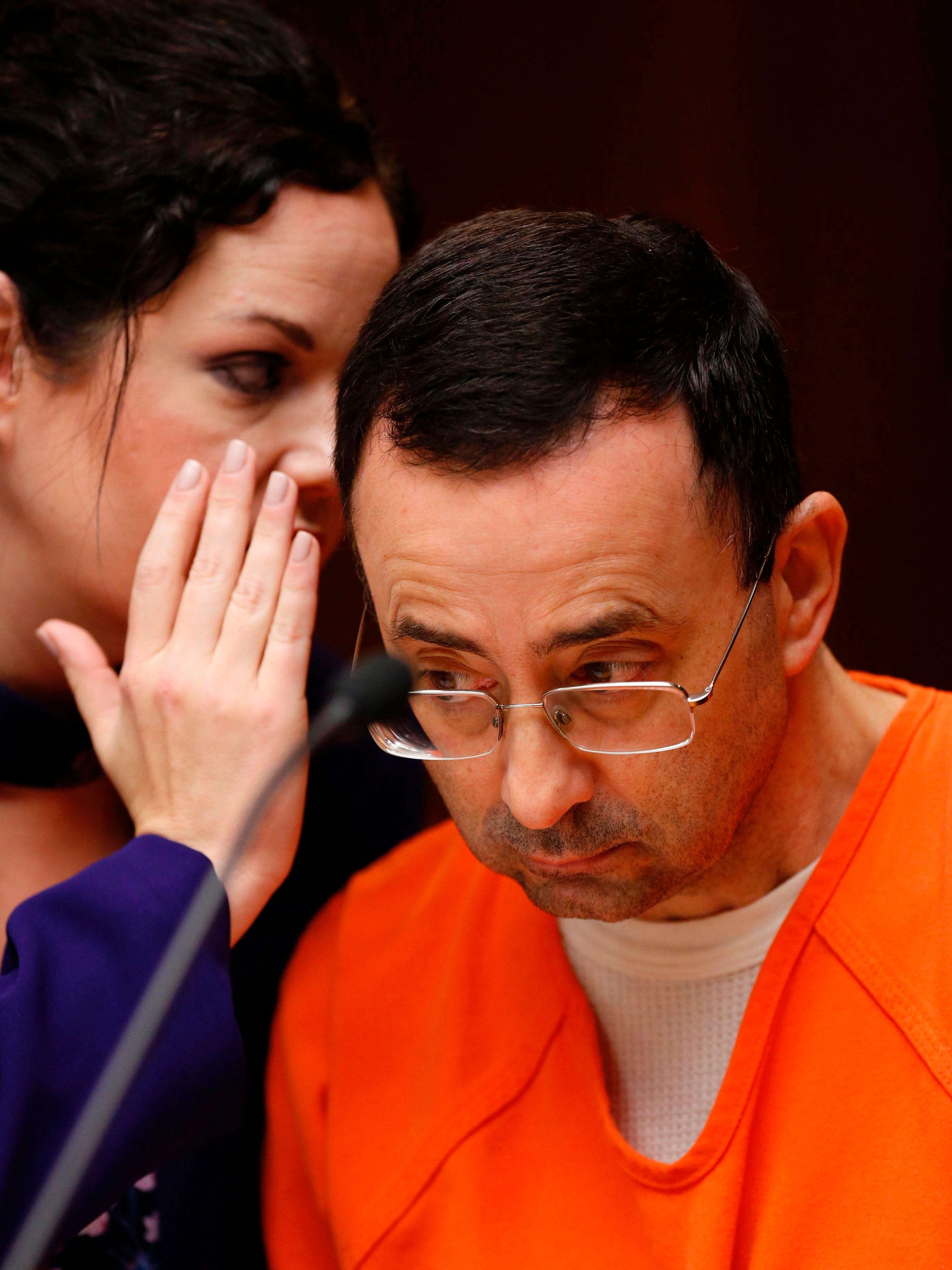 Former Michigan State University and USA Gymnastics doctor Larry Nassar with defense attorneys Shannon Smith.  State authorities have charged him with 22 counts of first-degree criminal sexual conduct, with a trial set for December. 4, 2017.