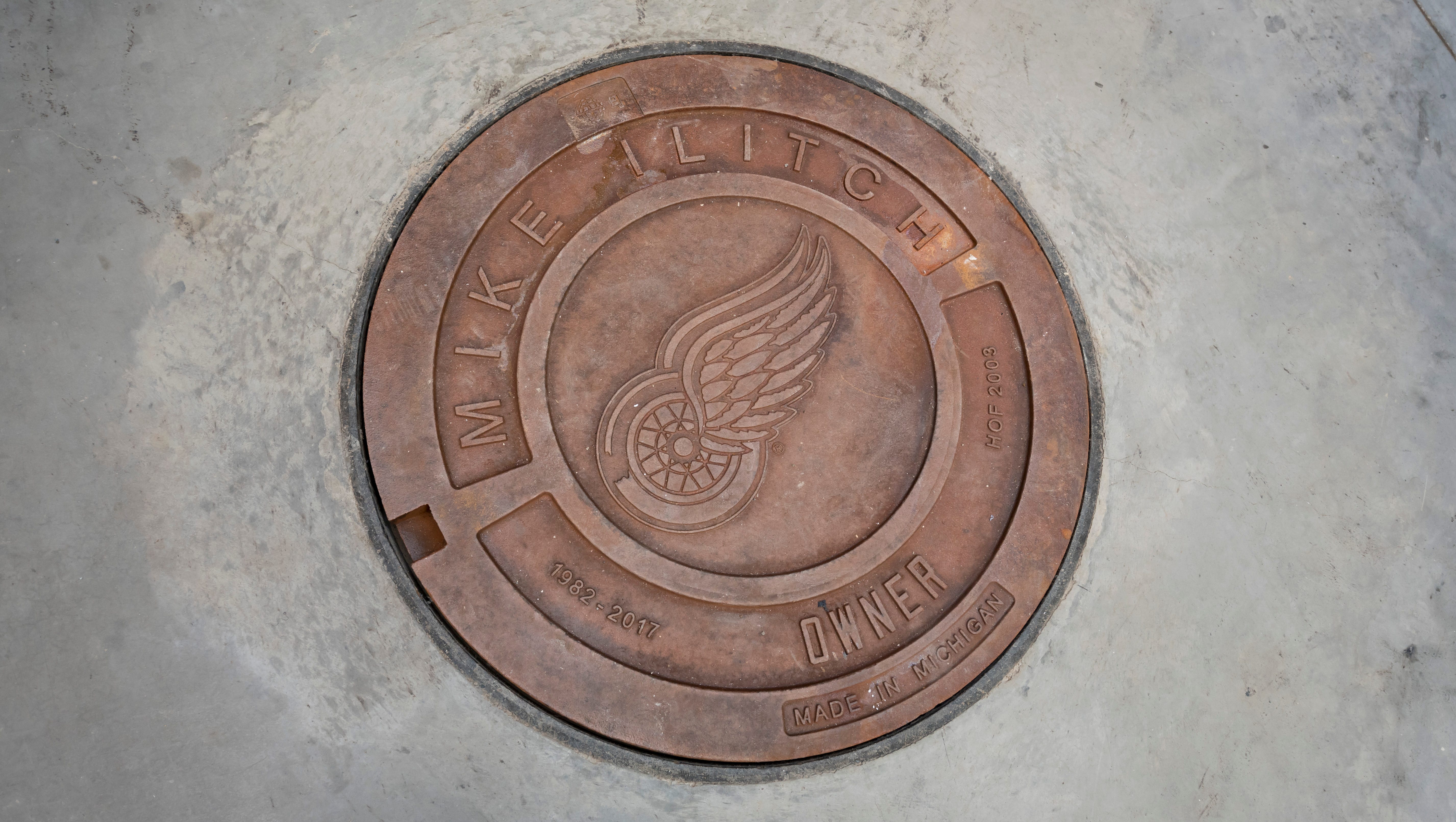 Manhole covers dedicated to Detroit greats, including the late owner of the Detroit Red Wings and Detroit Tigers, Mike Ilitch, line the floor of the concourse level.