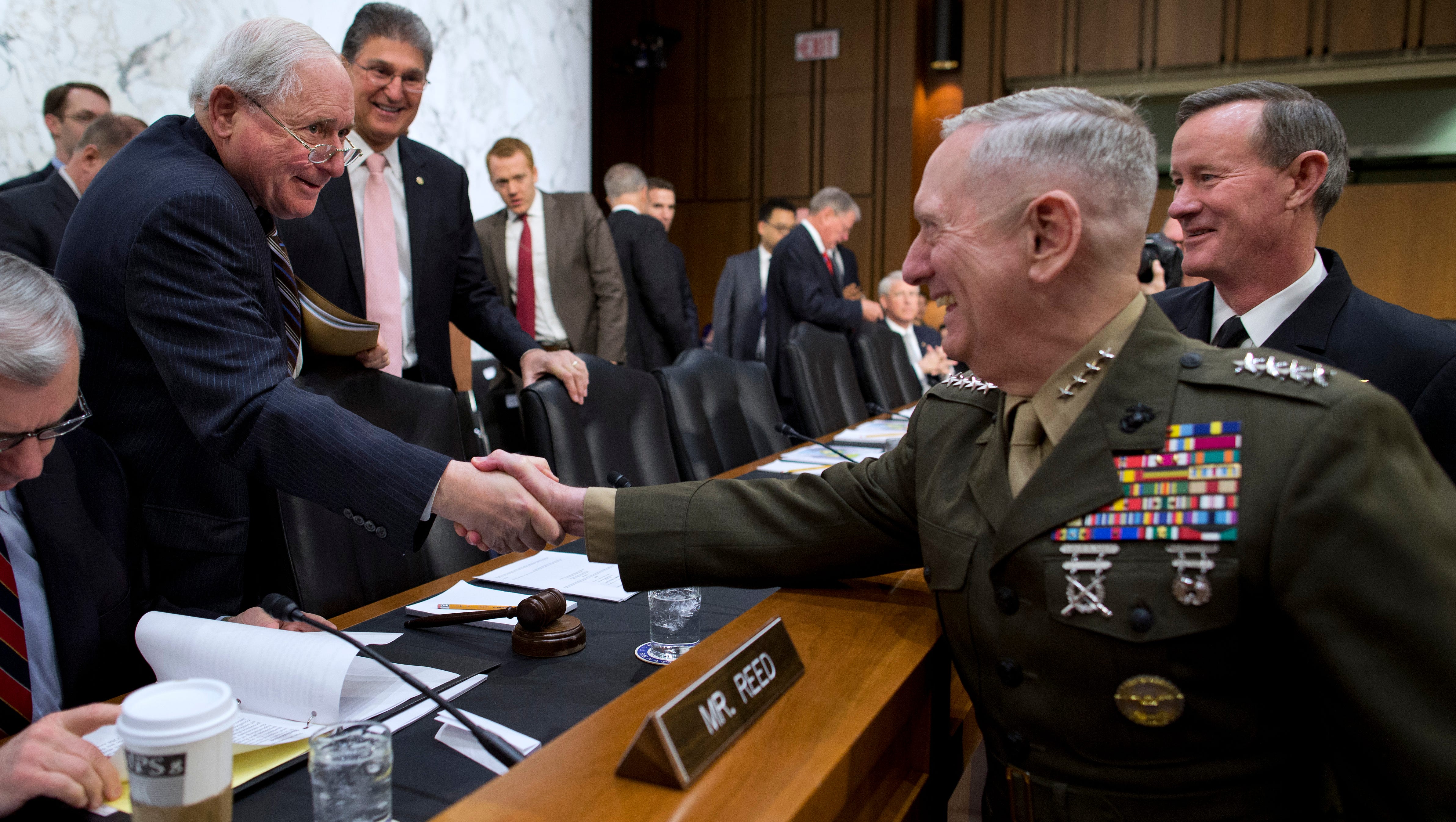 Sen. Carl Levin, left, accompanied by committee member Sen. Joe Manchin, D-W.Va., second from left, greets Marine Gen. James Mattis, commander, U.S. Central Command, center, and Navy Adm. William McRaven, commander, U.S. Special Operations Command, right, on Capitol Hill March 5, 2013, prior to the start of the committee's hearing to review of the Defense Authorization Request for Fiscal Year 2014 and the Future Years Defense Program.