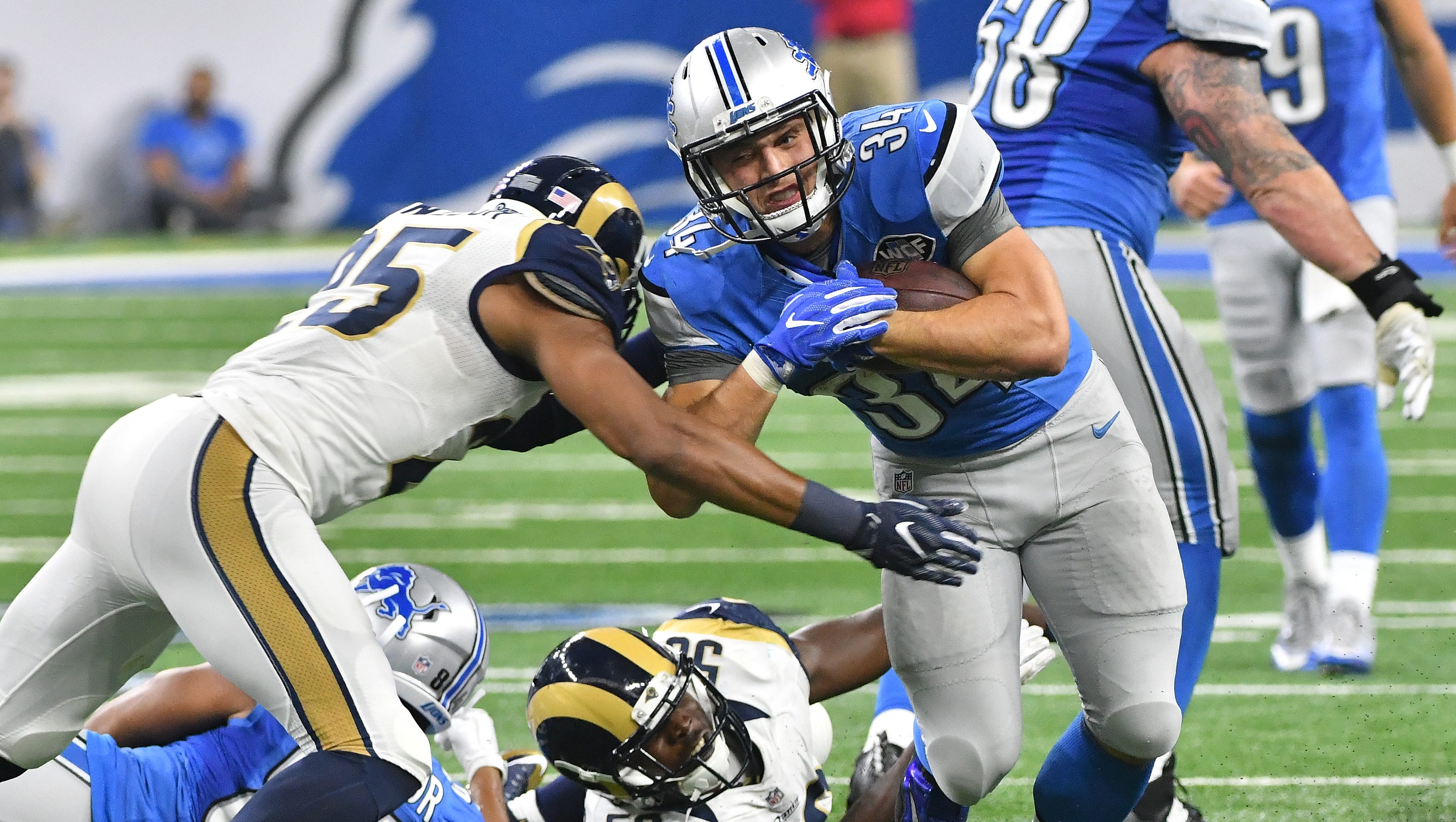 Lions running back Zach Zenner rumbles for yardage late in the fourth quarter, with Rams T.J. McDonald eventually bringing him down.