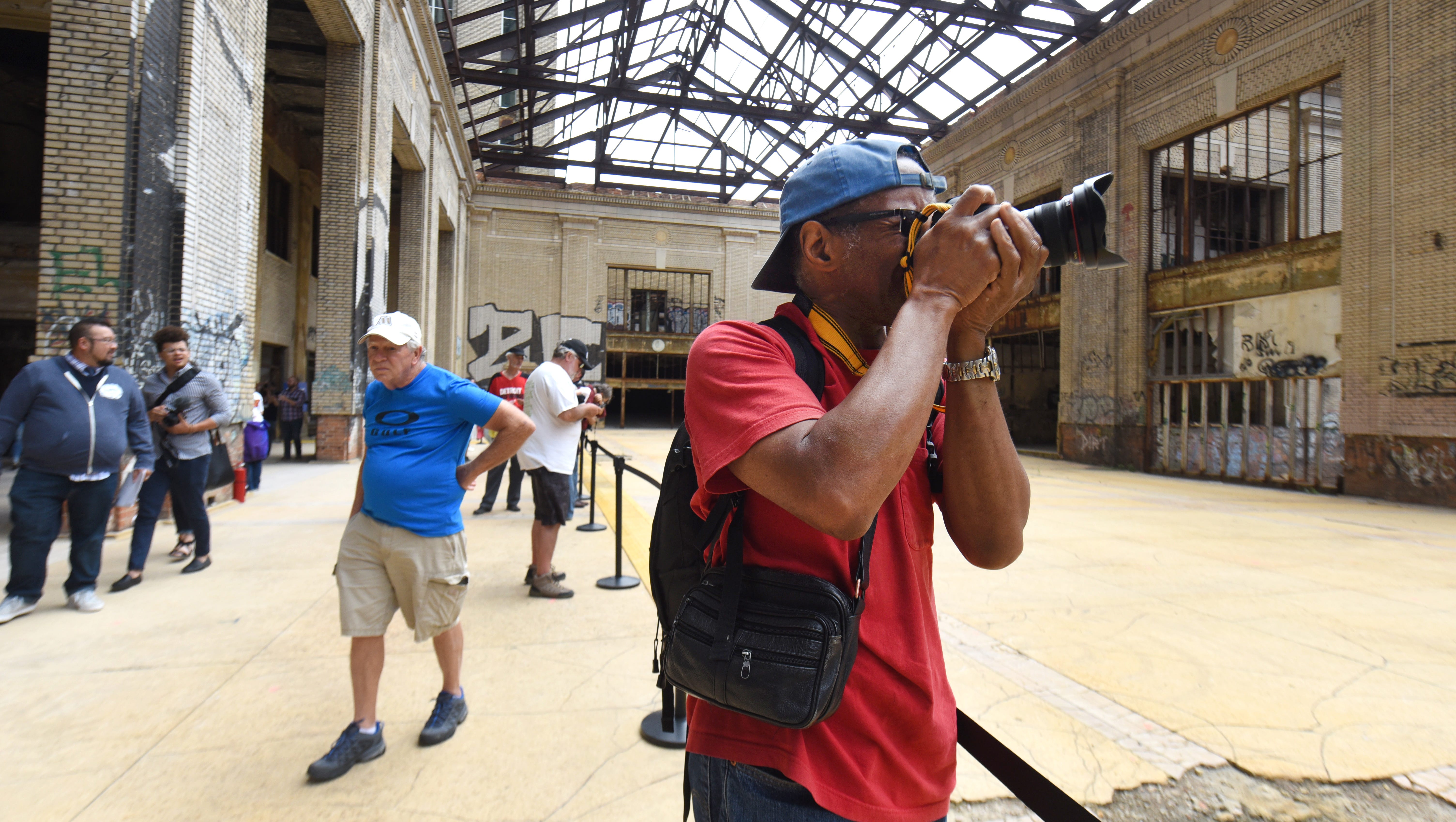 Photographer Ulysses Freeman of Detroit snaps hundreds of images of the concourse area in the Michigan Central Train Depot.