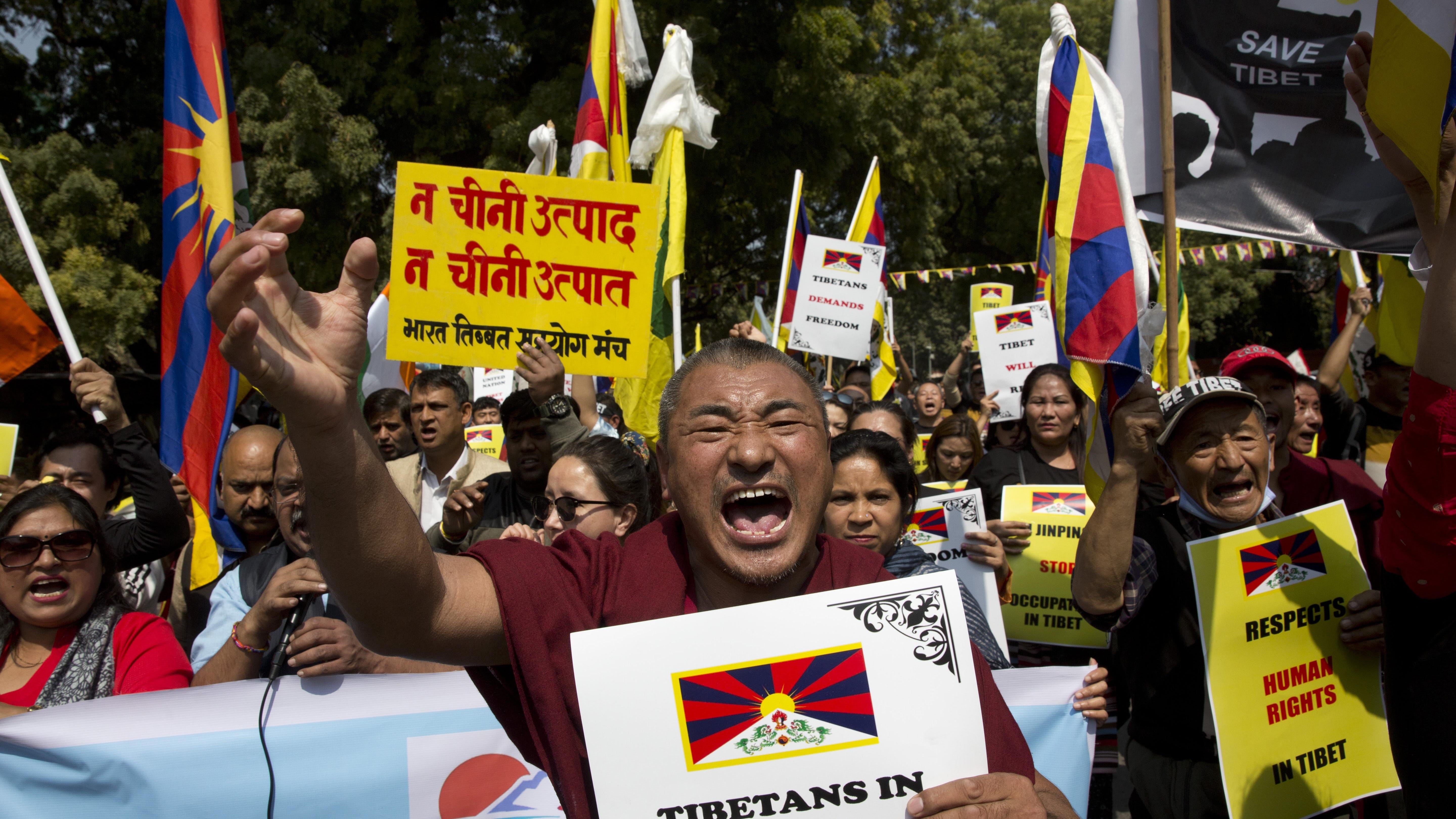 Exiled Tibetans shout slogans during a march to mark the 60th anniversary of the March 10, 1959, Tibetan Uprising Day, in New Delhi, India, Sunday, March 10, 2019.