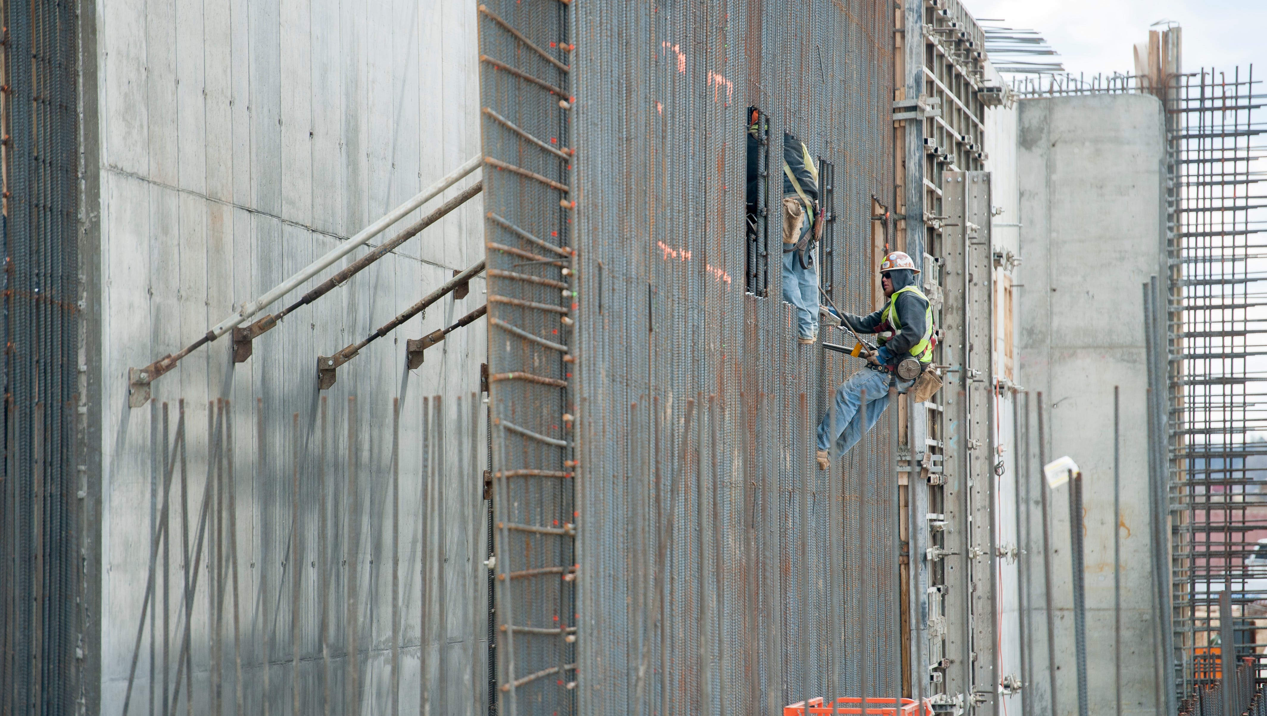 Laborers work on a wall at the construction site of the new Karegnondi Water Authority treatment plant.