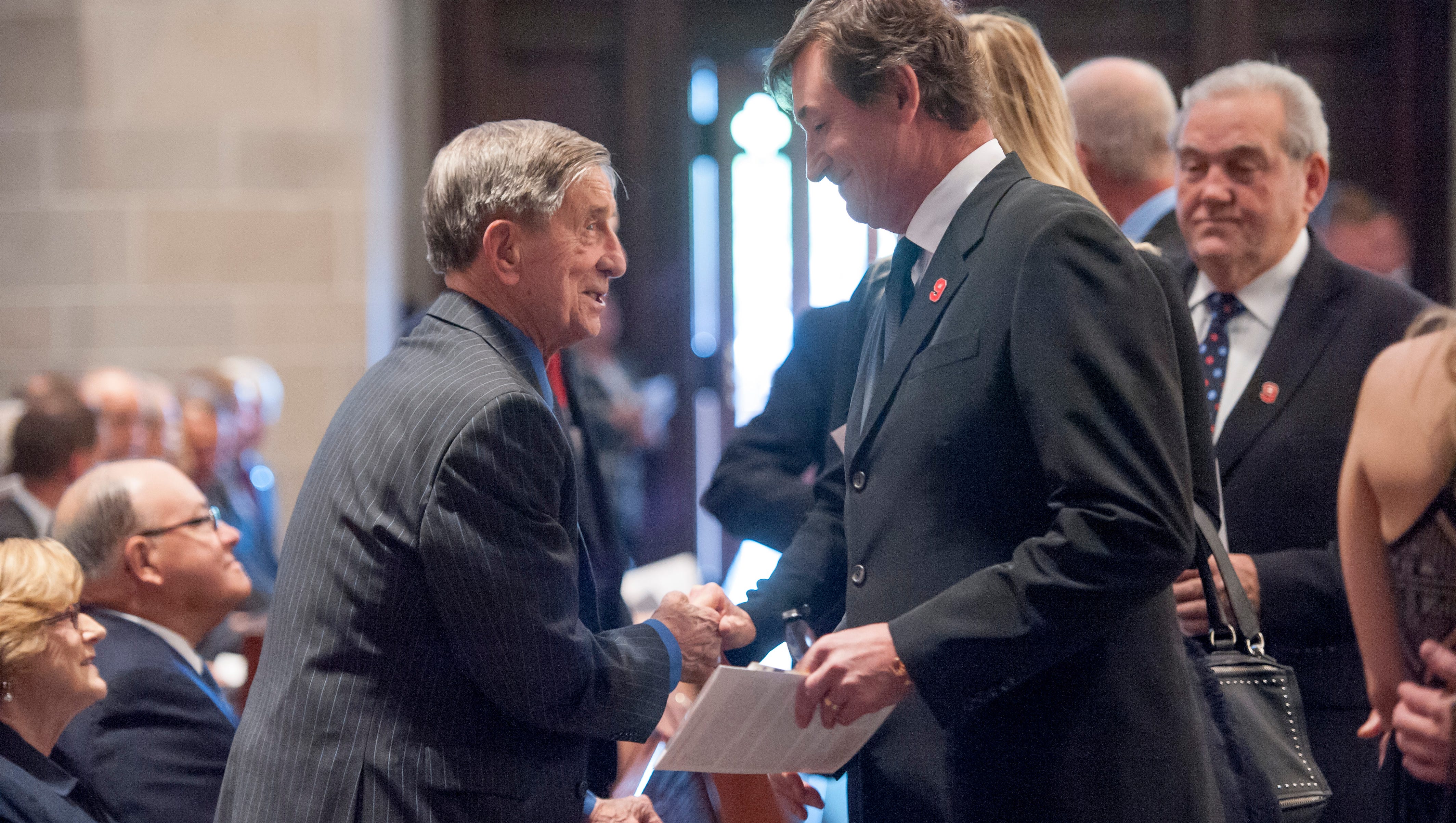 Former Gordie Howe teammate Ted Lindsay, left, and hockey legend Wayne Gretzky chat before the funeral service for Gordie Howe in 2016. Lindsay played with Howe and Sid Abel on the famed "Production Line."