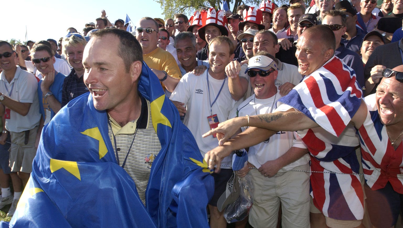 Billy Foster, Darren Clarke's caddie, is surrounded by European fans on the 18th hole at the 2004 Ryder Cup.