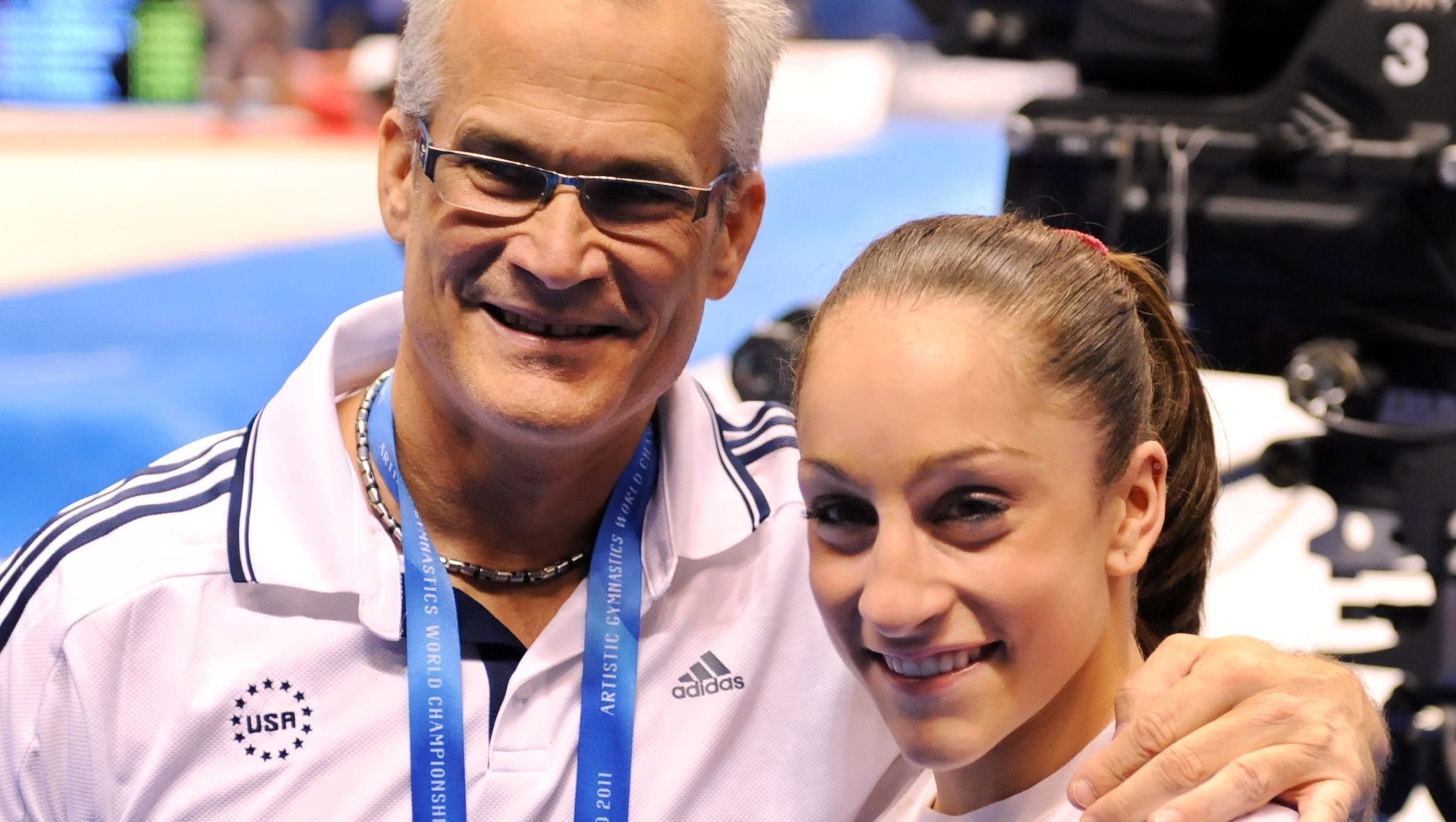 U.S. gymnast Jordyn Wieber celebrating her victory with her coach John Geddert in the women's all-around final at the World Gymnastics Championships in Tokyo. Geddert, coach of the U.S. women's 2012 London Olympics gold medal team, has been suspended by USA Gymnastics pending completion of an investigation by the sport governing body He was the personal coach to Wieber, but has come under intense scrutiny because of close personal and professional relationships to Larry Nassar, the former national team doctor convicted of sexual abuse of young gymnasts under the guise of medical treatment.