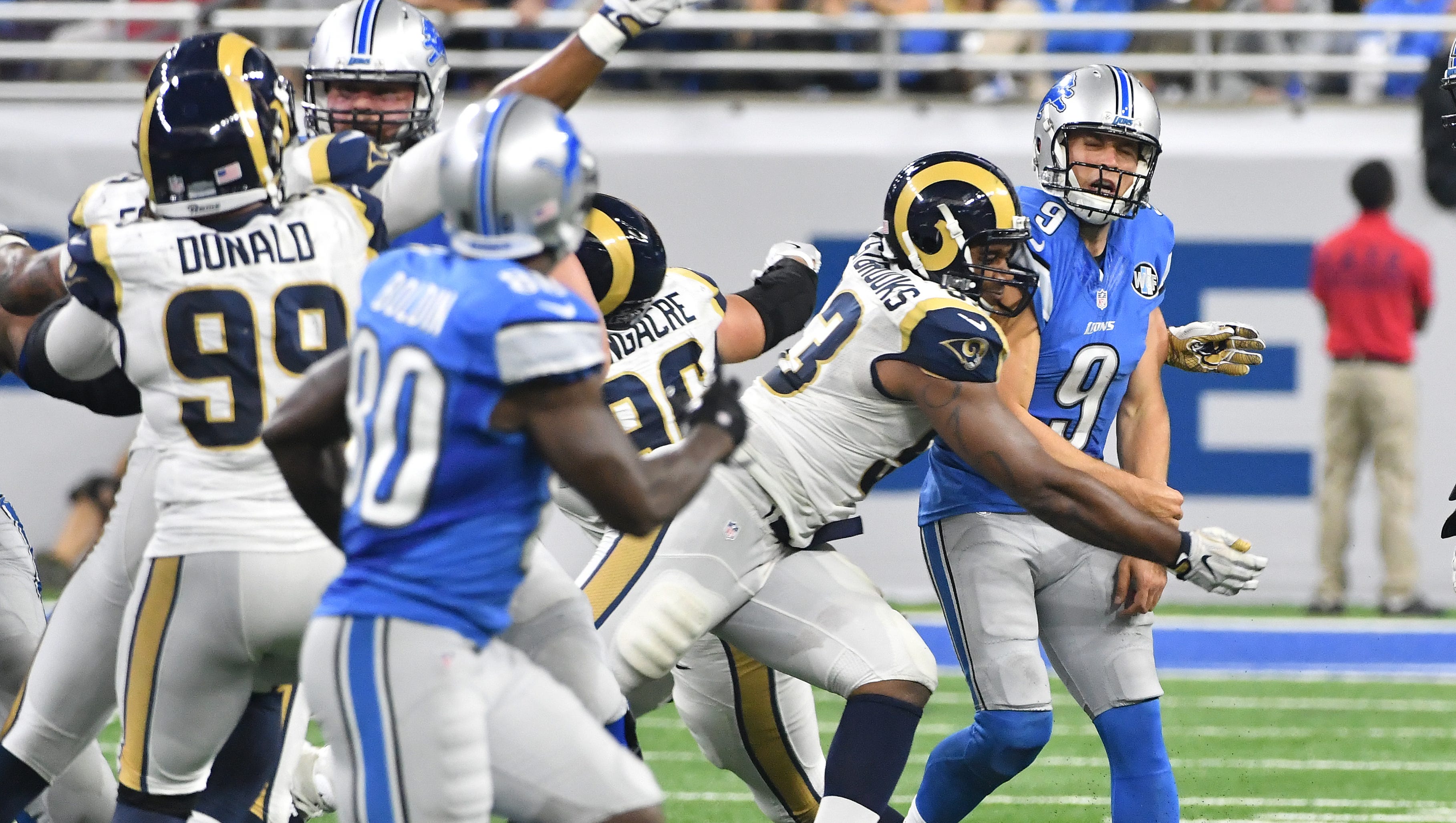 Lions quarterback Matthew Stafford pays the price as he gets slammed by Rams Ethan Westbrooks on his completion to wide receiver Anquan Boldin on Detroit's game winning drive late in the fourth quarter.
