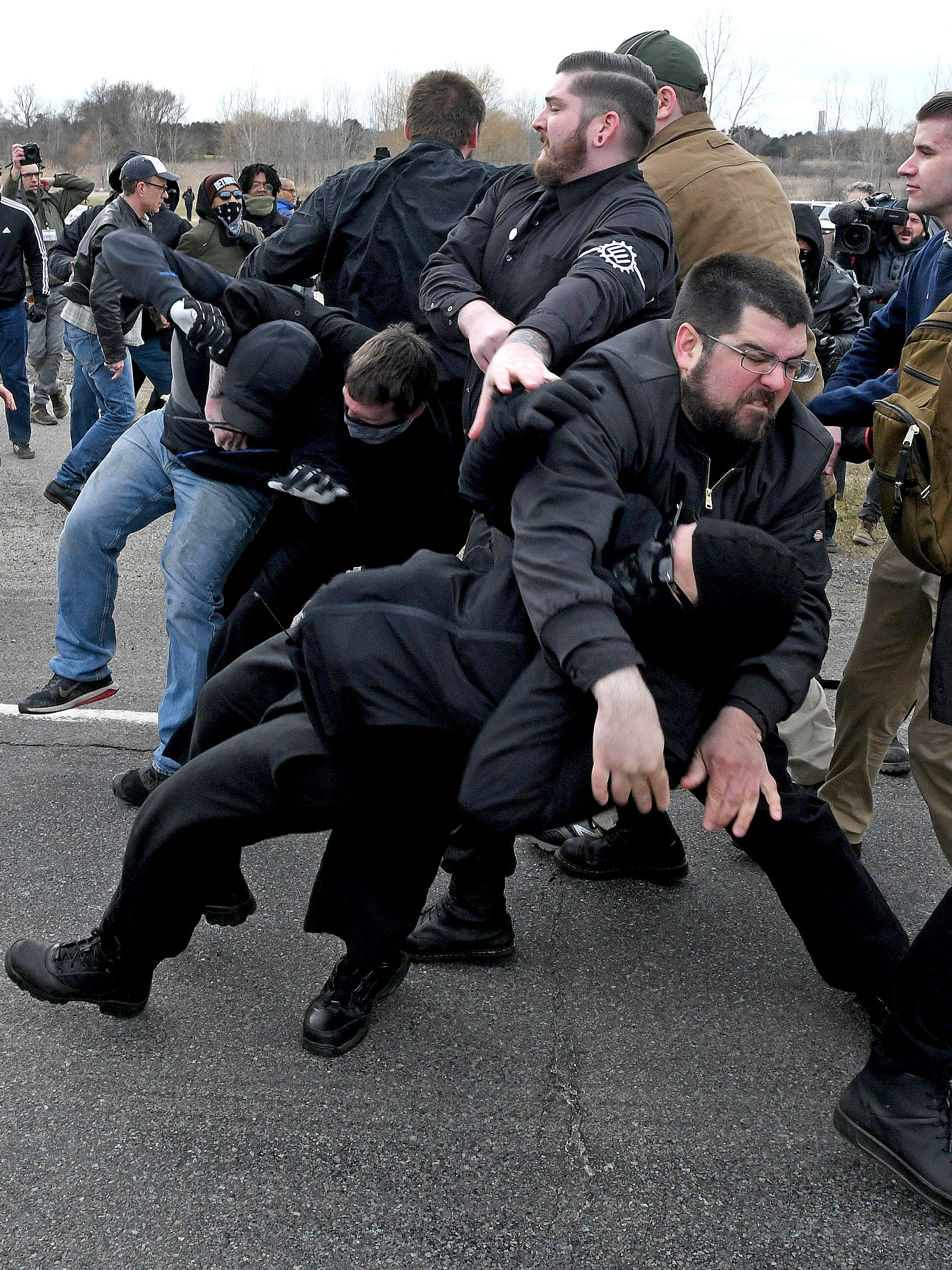 Matthew Heimbach, top, leader of the white nationalist Traditional Workers Party, throws a protester to the ground.