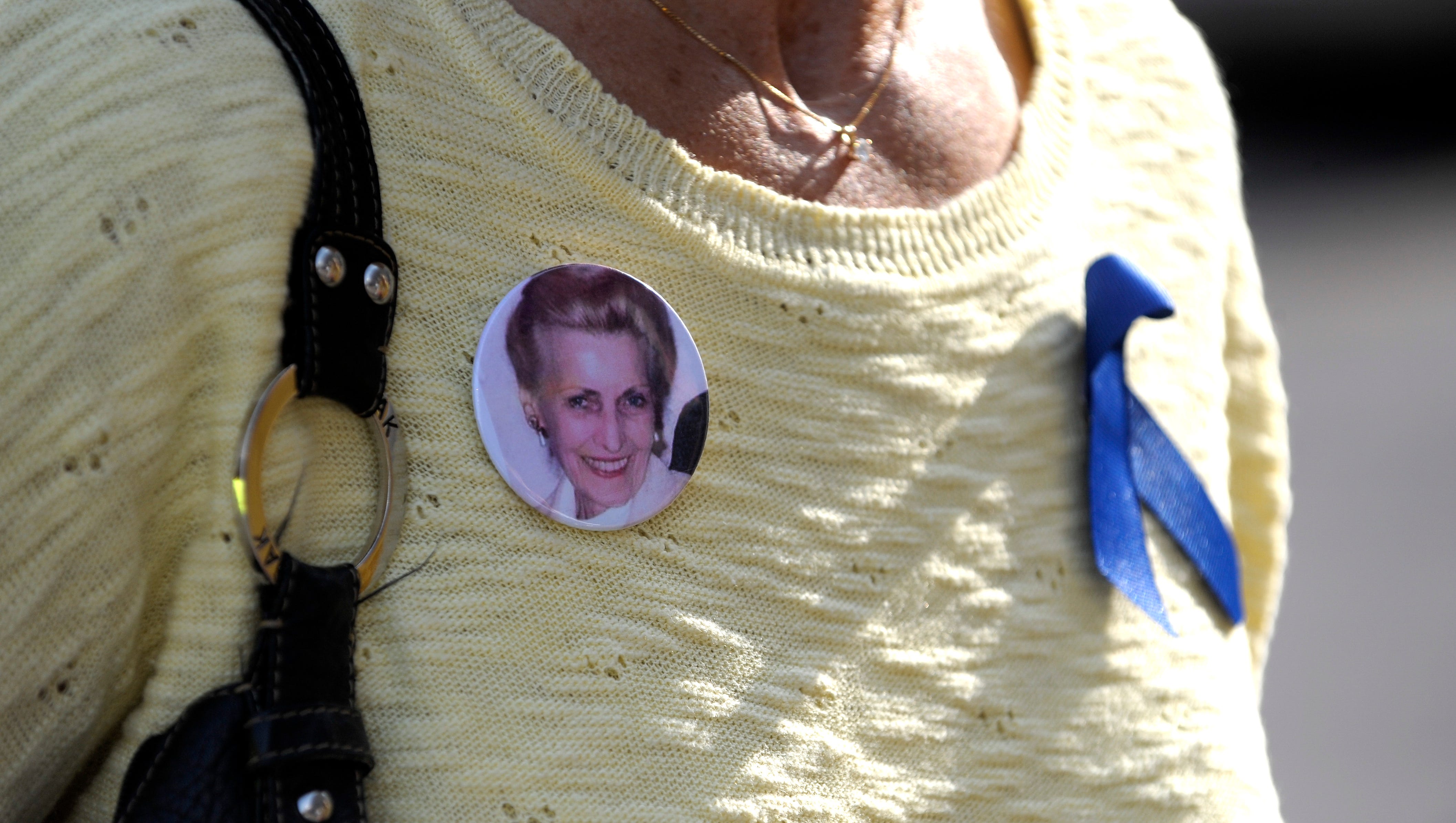 Sydney Zaremba, 60, of Lake Orion, wears a button of her mother, Helene Zaremba, who died 3 months after beginning treatment for lymphoma by Dr. Fata.