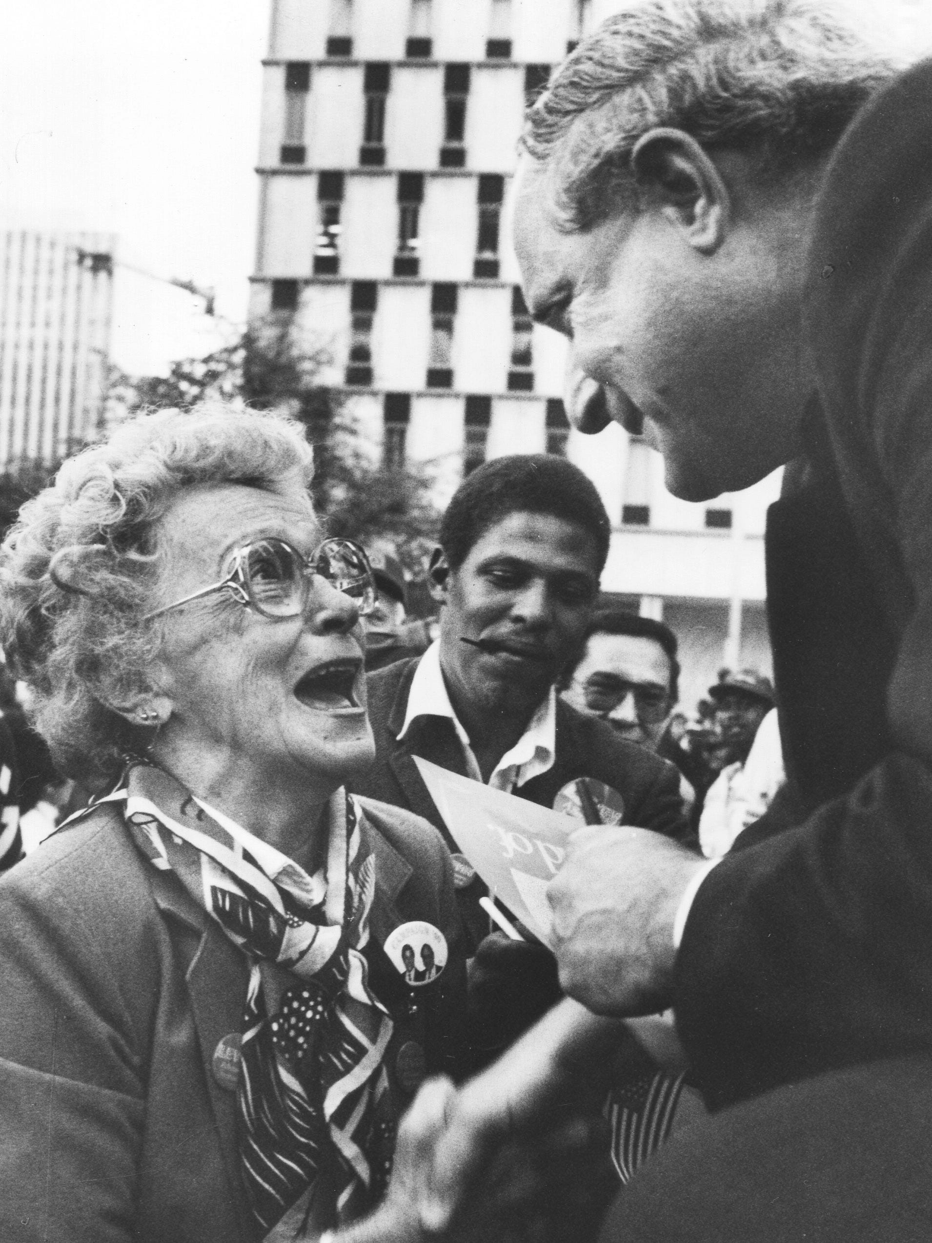 Sen. Carl Levin greets Helen Forest while campaigning in November 1990.