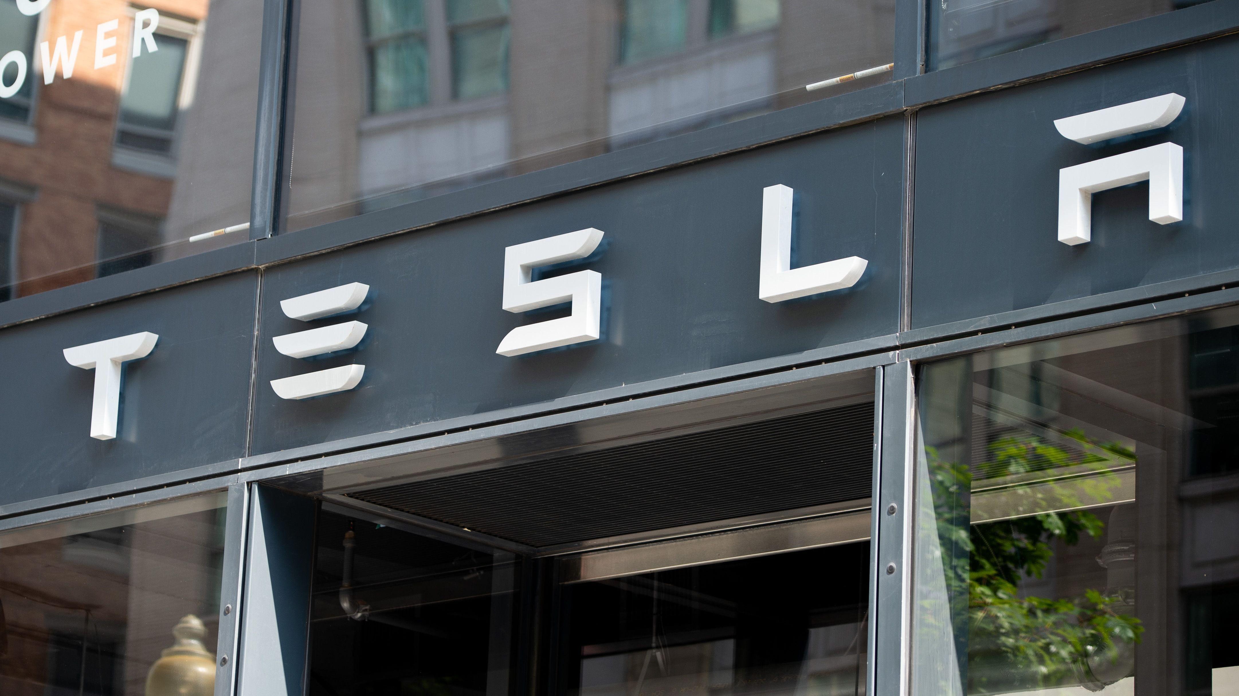 The Tesla logo is seen outside of their showroom in Washington, D.C. Tesla Inc. said it plans to raise average vehicle prices by about 3 percent globally after it reversed a decision to shut down most of its stores.