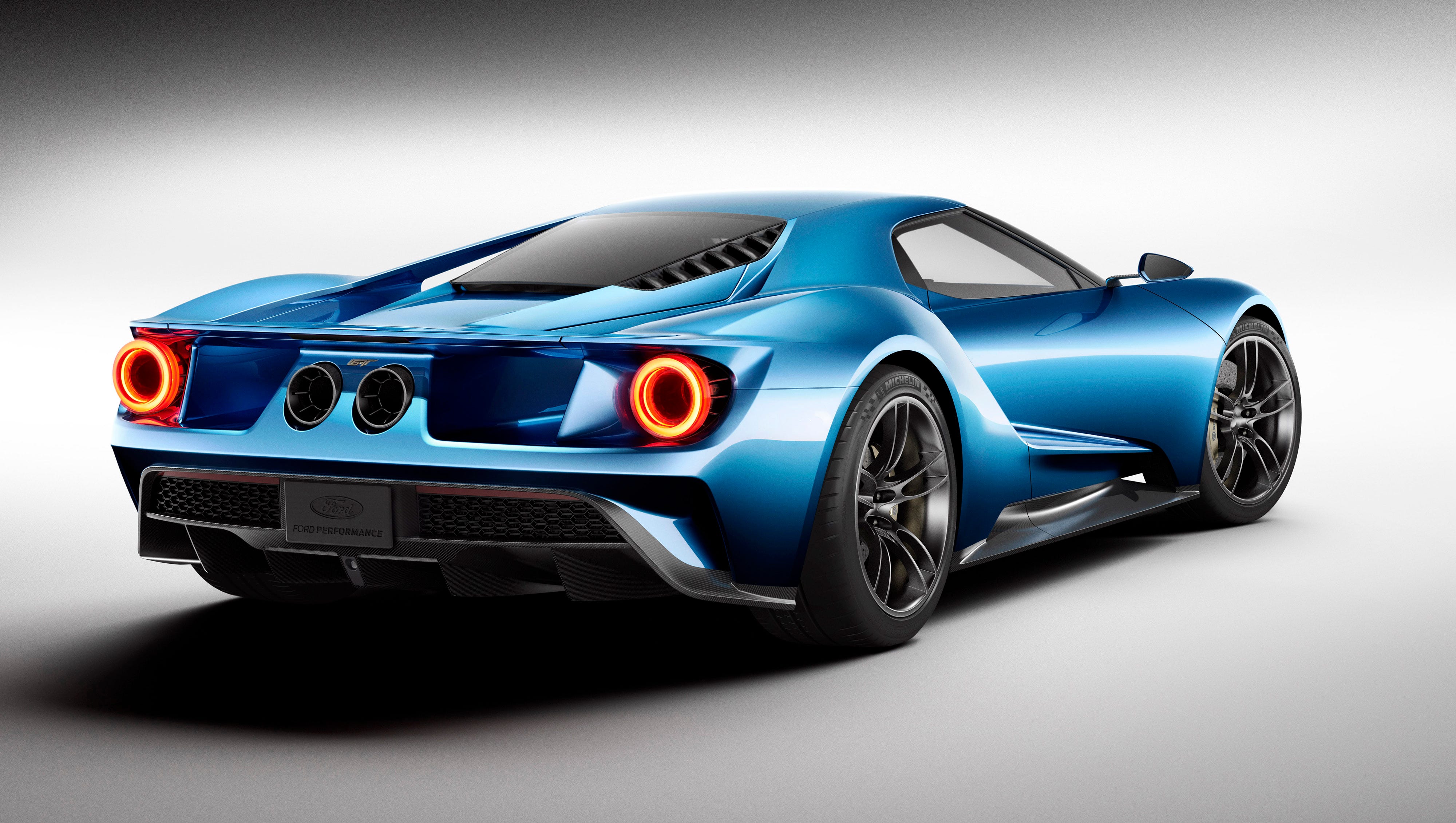 The all-new carbon-fiber Ford GT supercar features rear-wheel drive, a mid-mounted engine, and a sleek, aerodynamic, two-door coupe body shell.