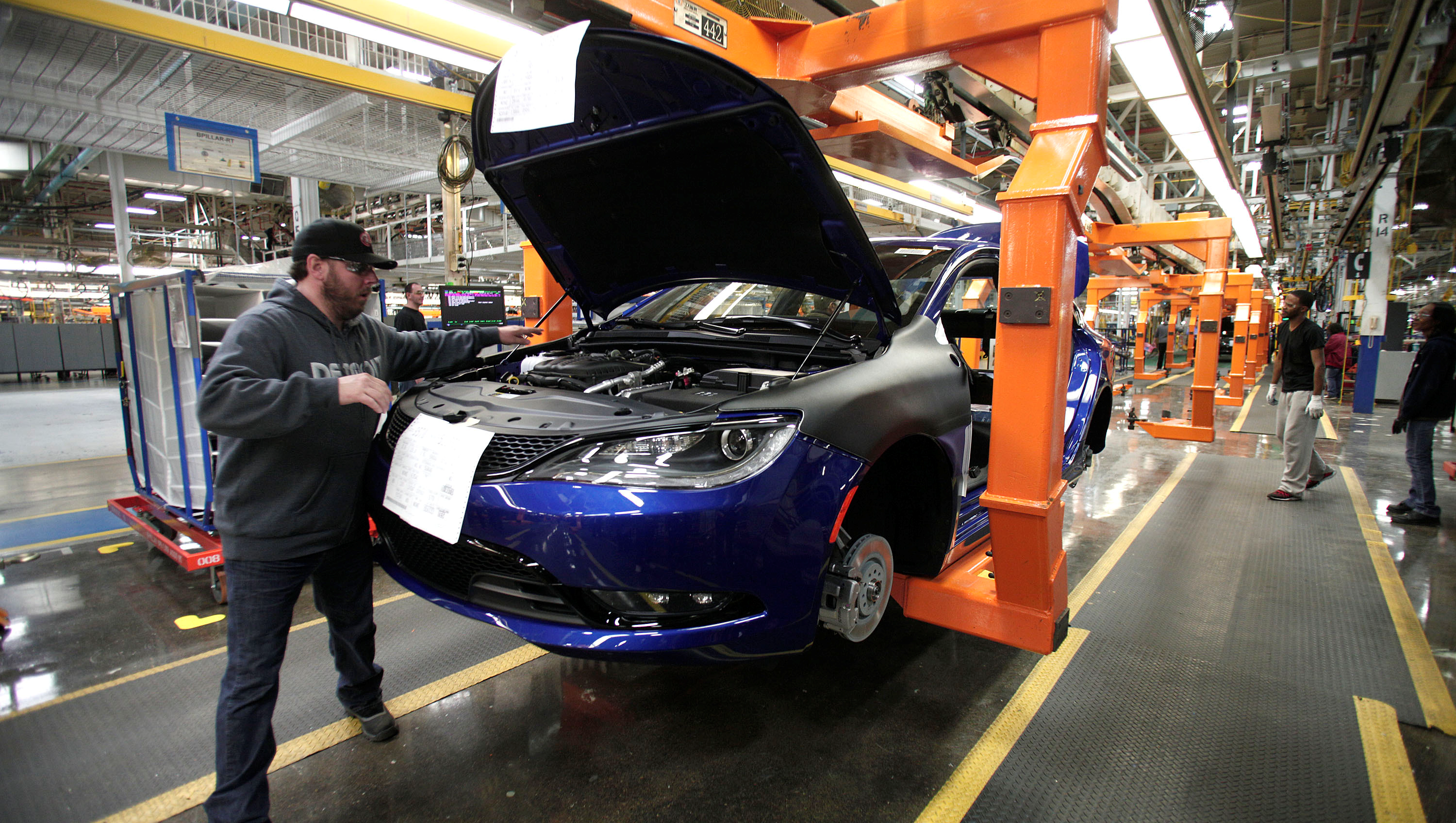 A worker assembles a 2015 Chrysler 200 at the Sterling Heights Assembly Plant March 14, 2014 in Sterling Heights, Michigan.