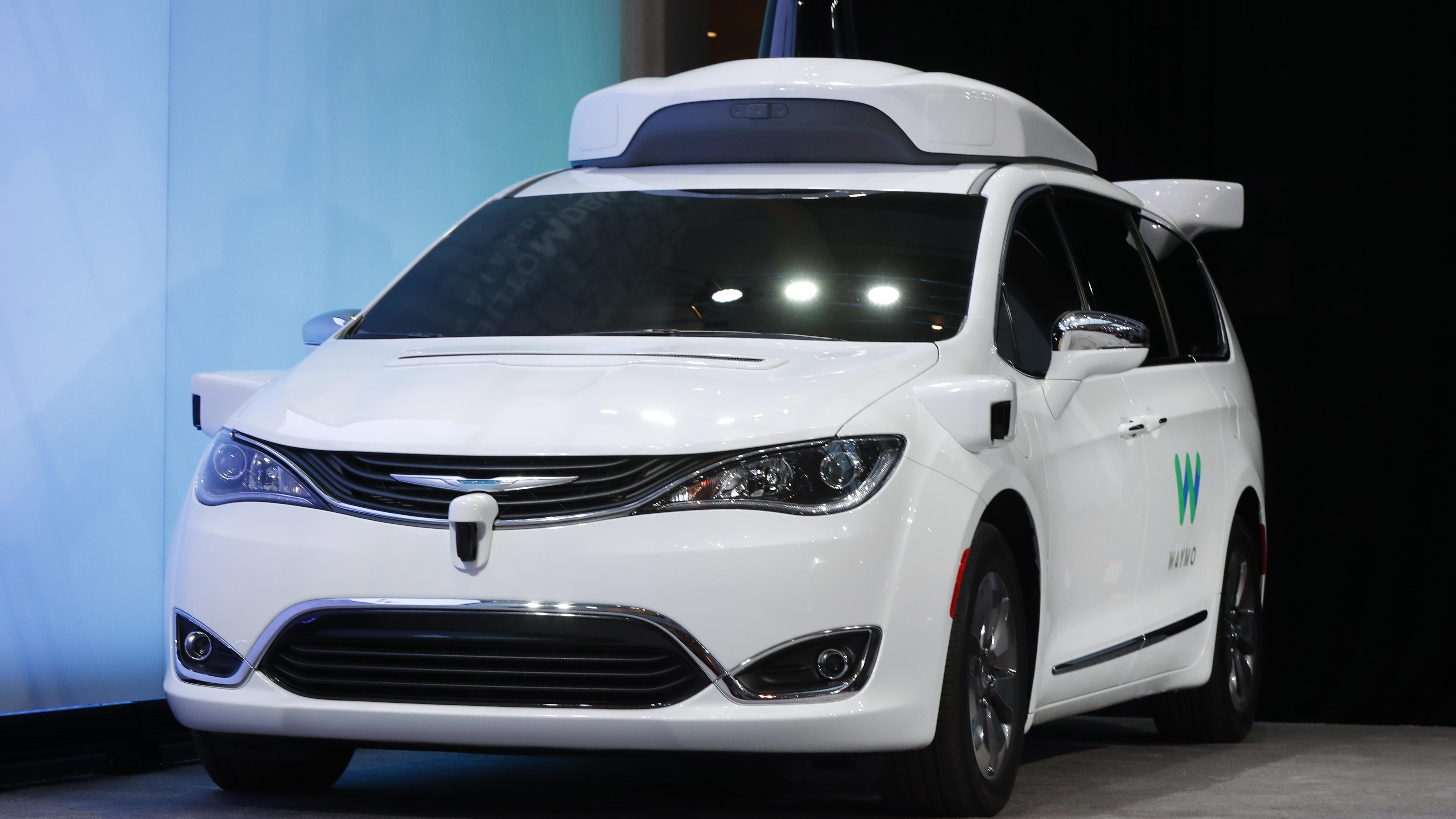 A Chrysler Pacifica hybrid outfitted with Waymo's suite of sensors and radar is shown at the North American International Auto Show in Detroit.