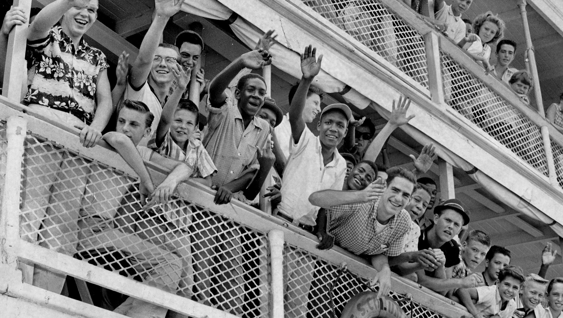 Detroit newspaper carriers wave from a Boblo boat in August 1959.