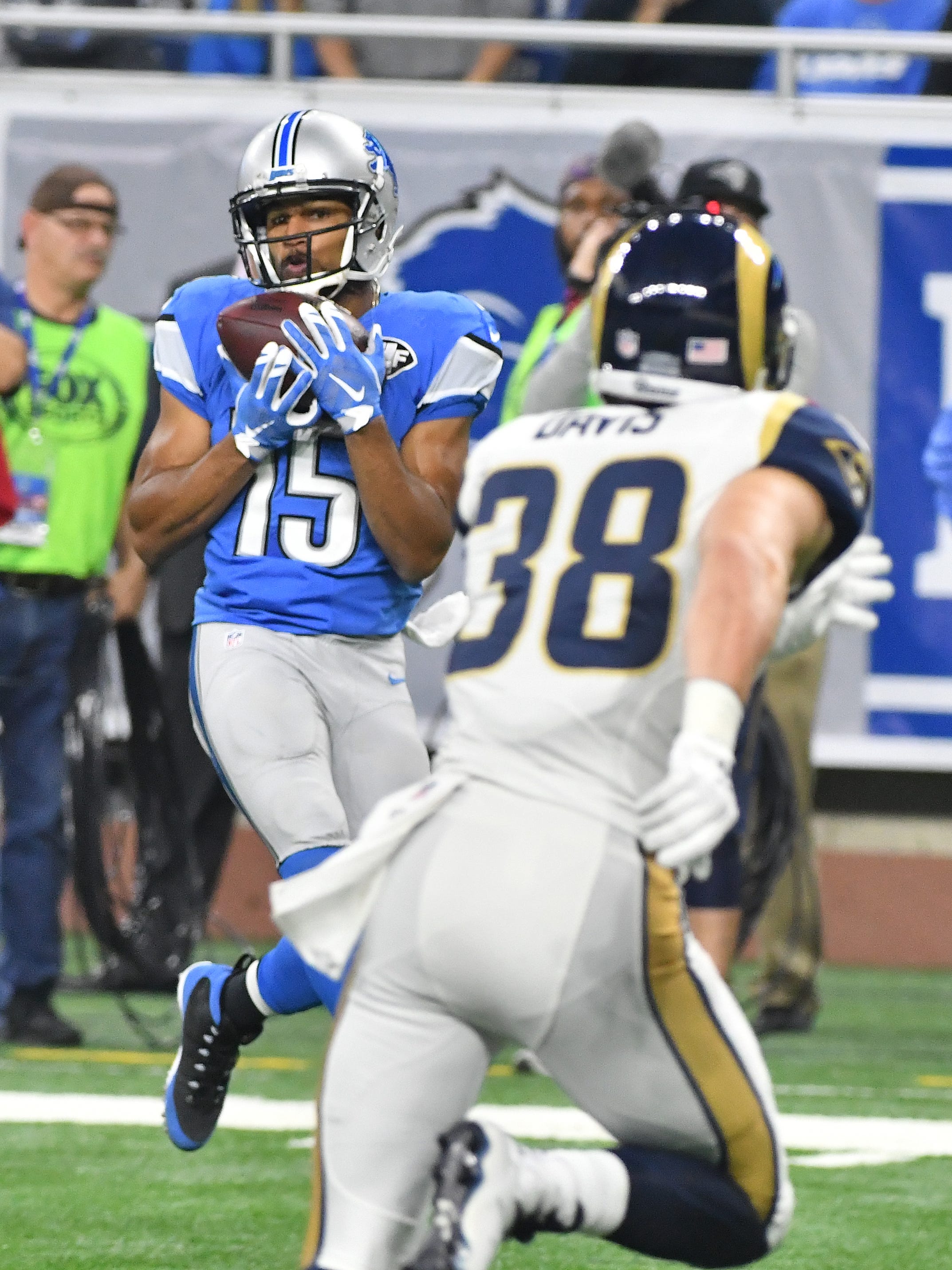 Lions wide receiver Golden Tate pulls down a reception in front of Rams Cody Davis in the fourth quarter.