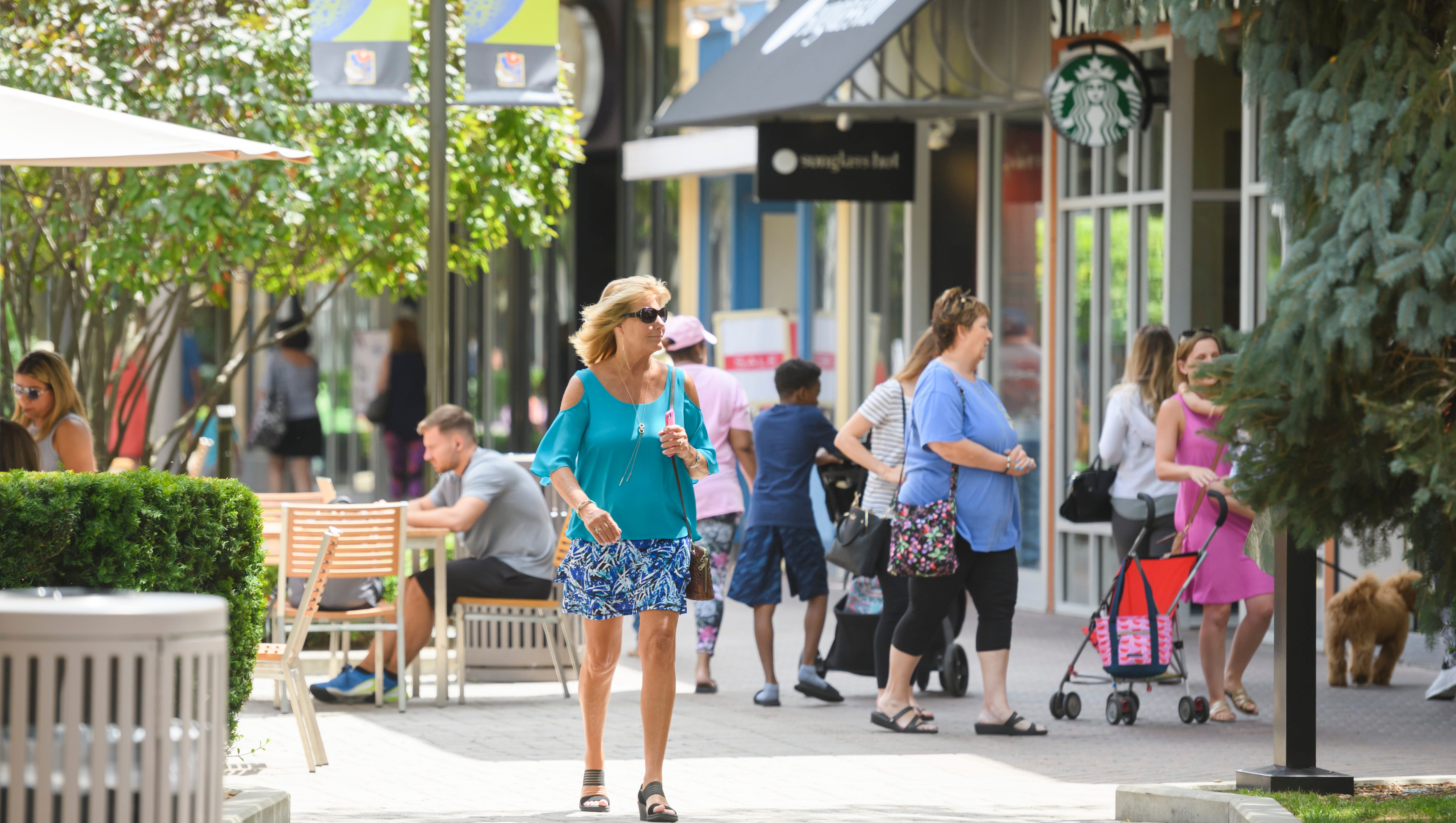 Shoppers enjoy a warm summer afternoon at the outdoor Patridge Creek, in Clinton Two., July 18, 2018.