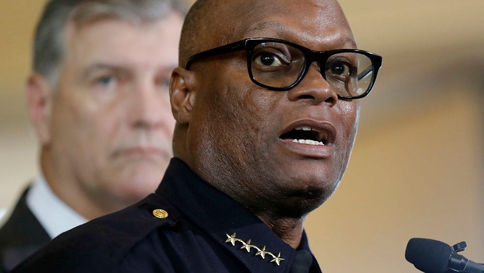 Dallas police chief David Brown, front, and Dallas mayor Mike Rawlings, rear, talk with the media during a news conference, Friday, July 8, 2016, in Dallas.
