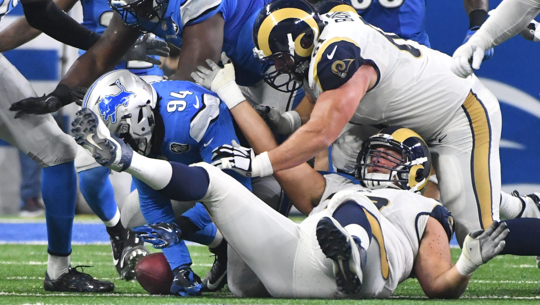 Lions defensive end Ziggy Ansah tries to recover a fumble by Rams quarterback Case Keenum, who ended up fighting back and recovering it in the second quarter.