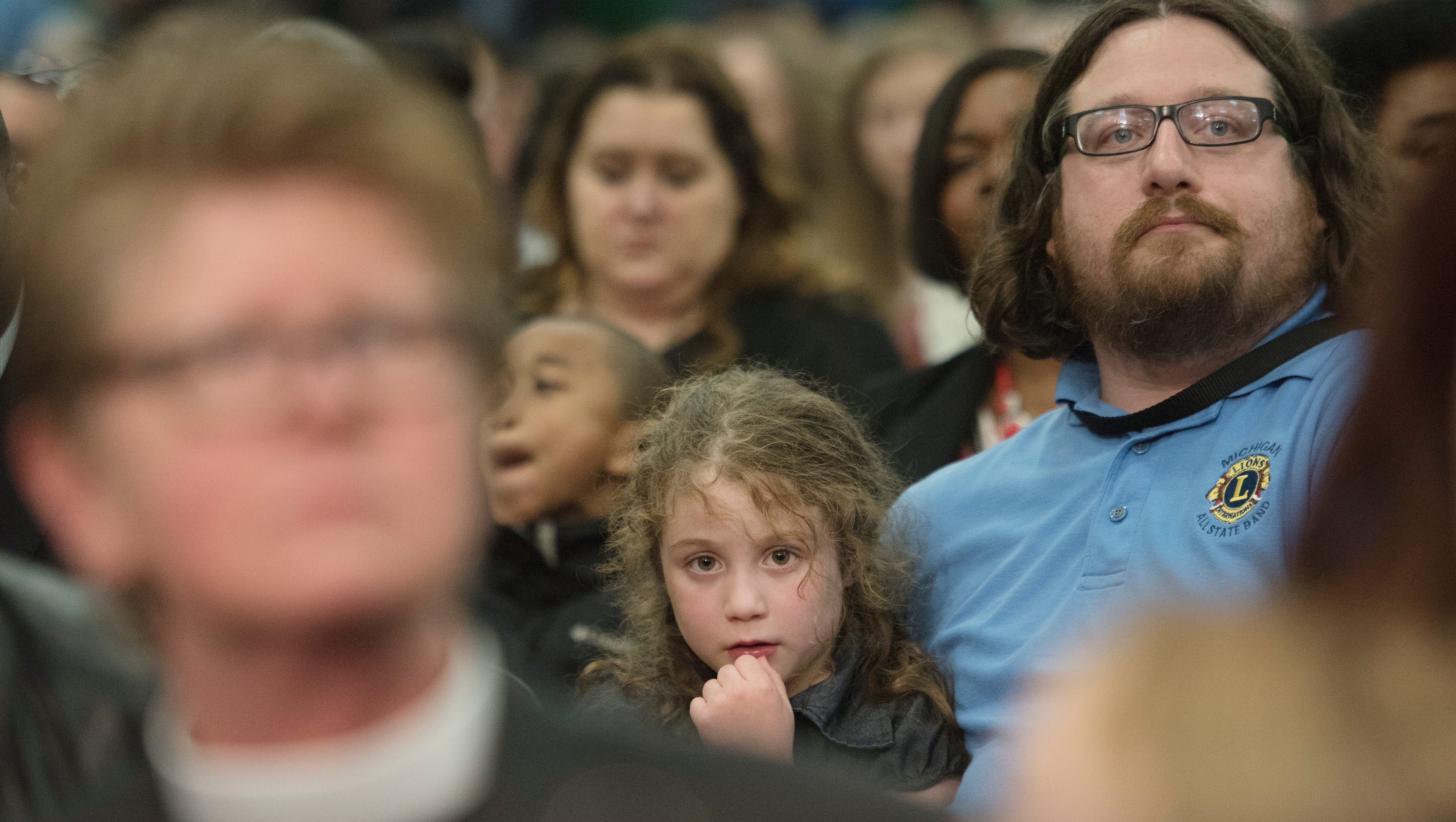 Cheyenne Russell, 5, and father Jason Russell of Flushing Township listen during the presiden'ts speech.