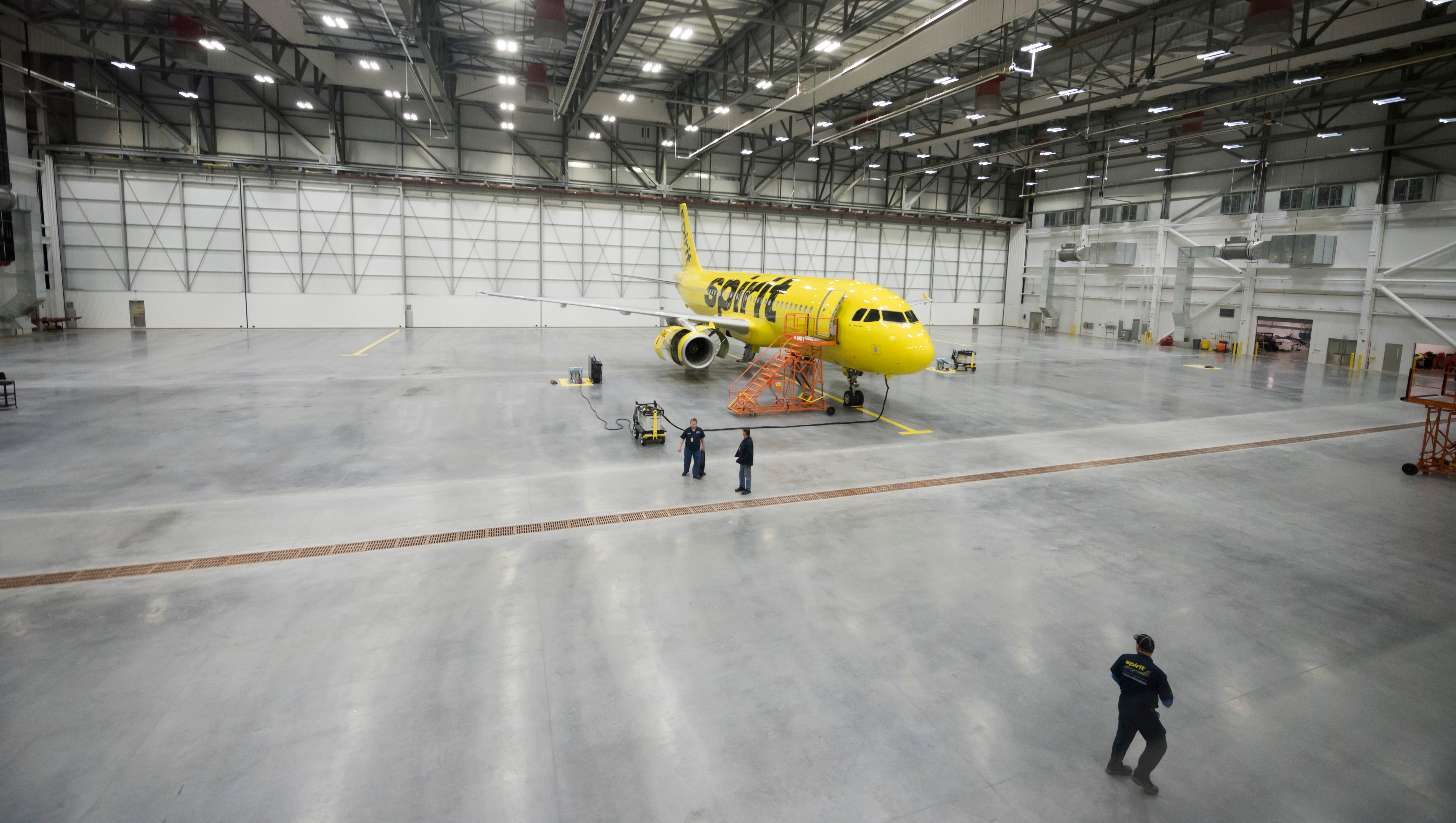 An A320 "operational spare" airplane sits in the main hangar bay.