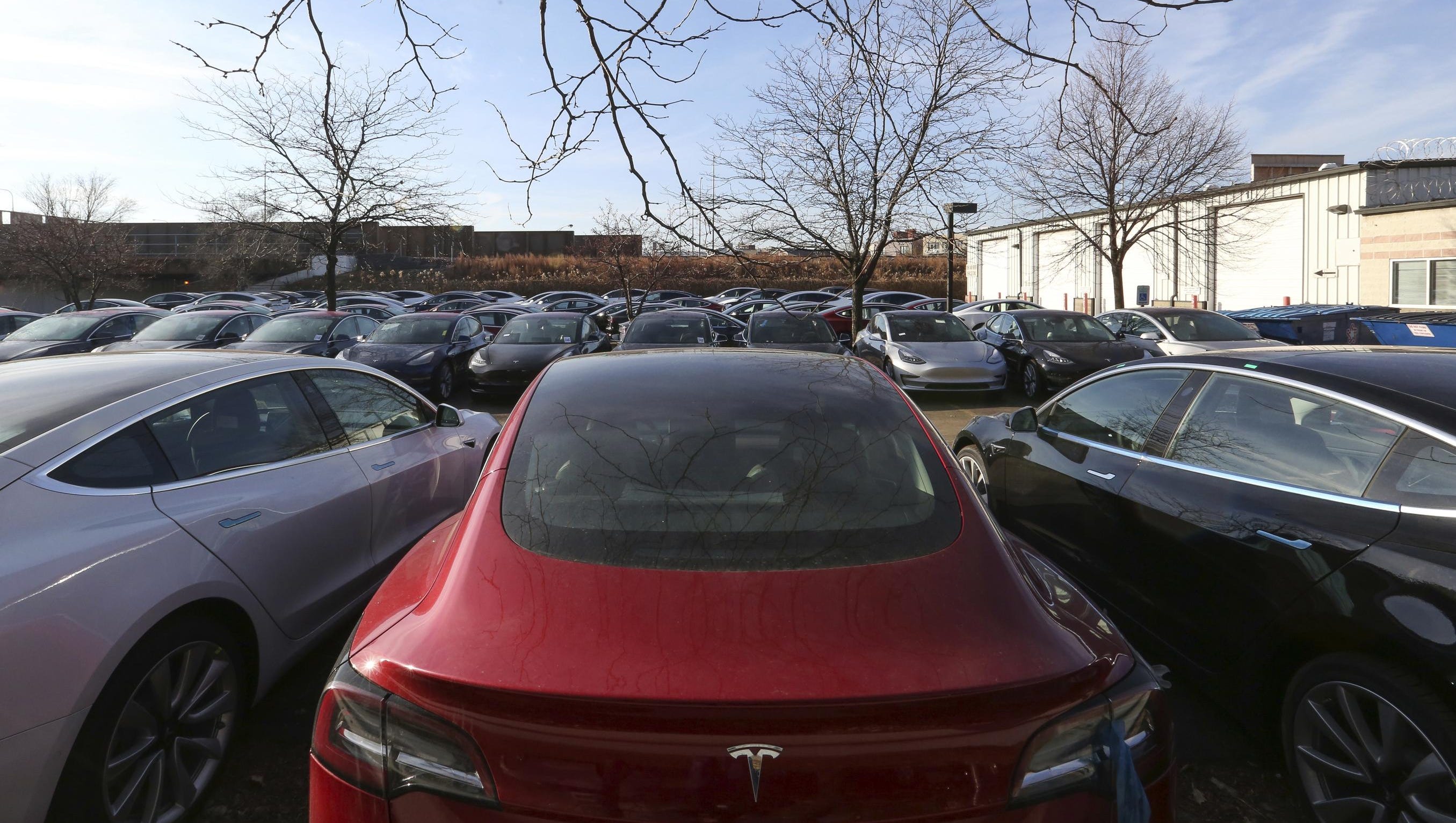 In this Dec. 18, 2018, photo Tesla vehicles sit in a parking lot in Chicago. Tesla paint issues  held up many Tesla orders as a supplier was brought in from August-December to touch up paint  issues.