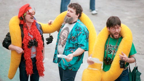 Jake "The Snake" Roberts fans get in the spirit before the bell tolls at WrestleMania III.