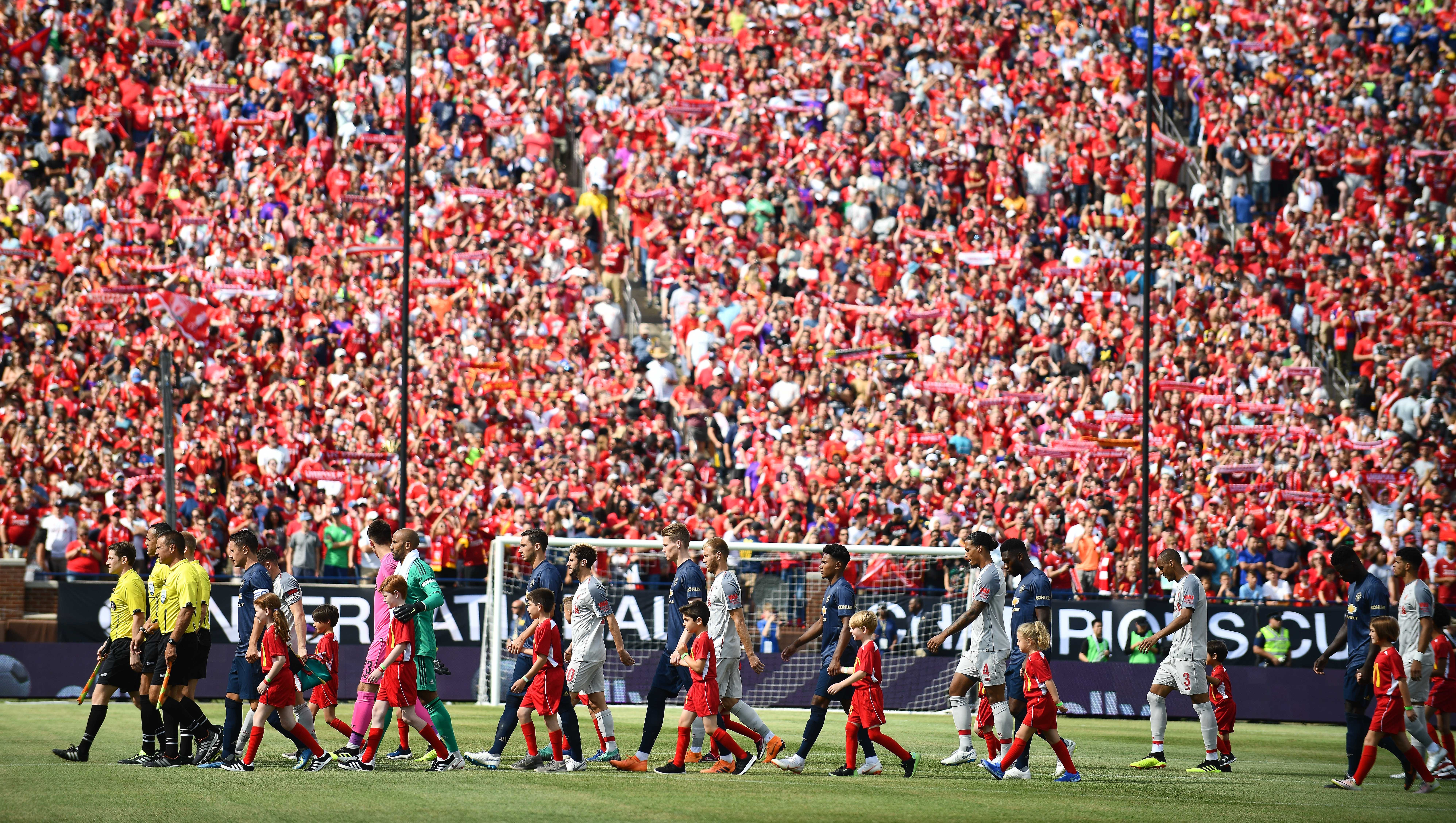 Manchester United and Liverpool make their way onto the field as over 100,000 fans cheer them on at The Big House for Saturday's International Champions Cup match.