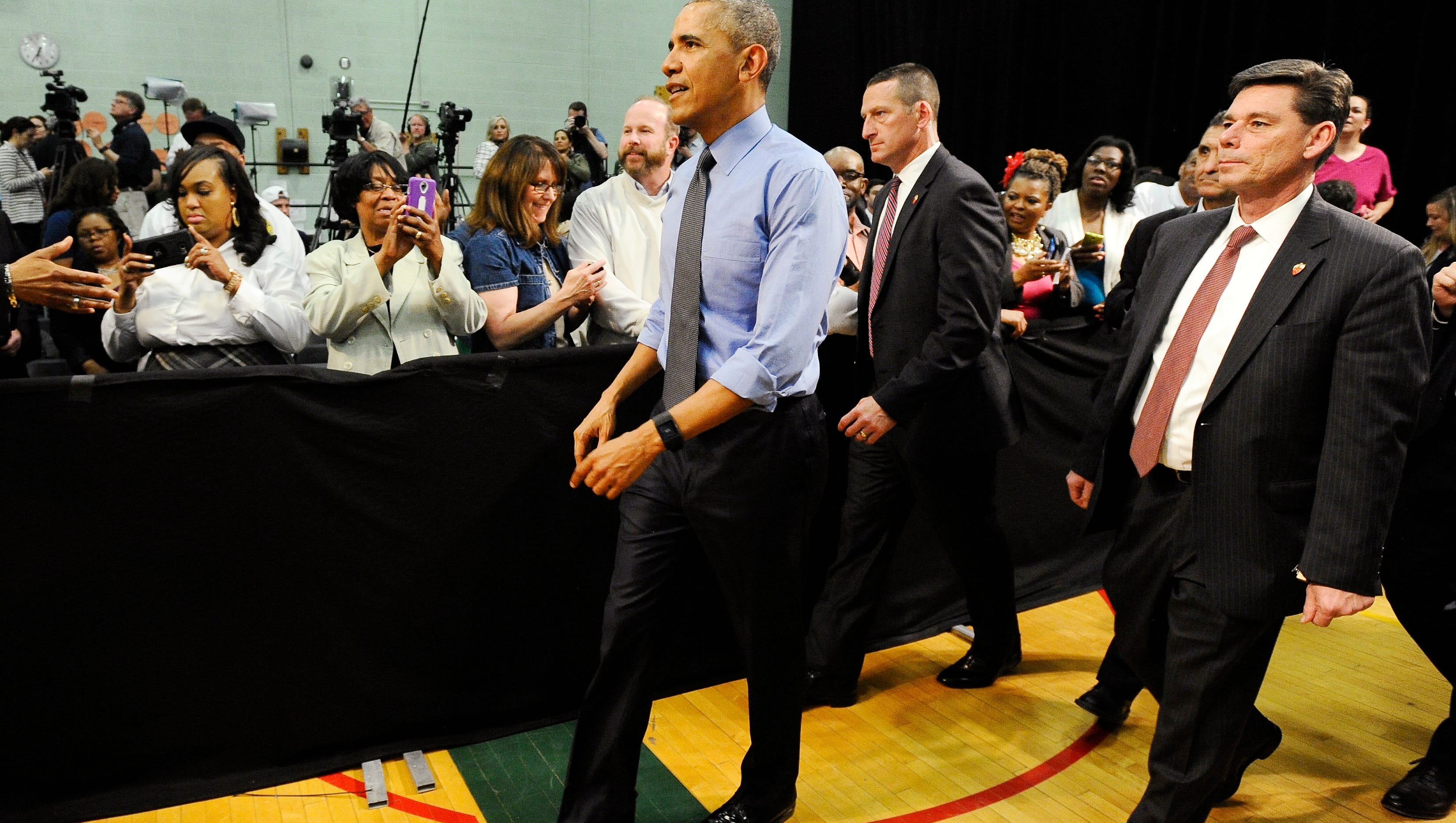 President Obama walks off after his remarks at Northwestern High School in Flint.