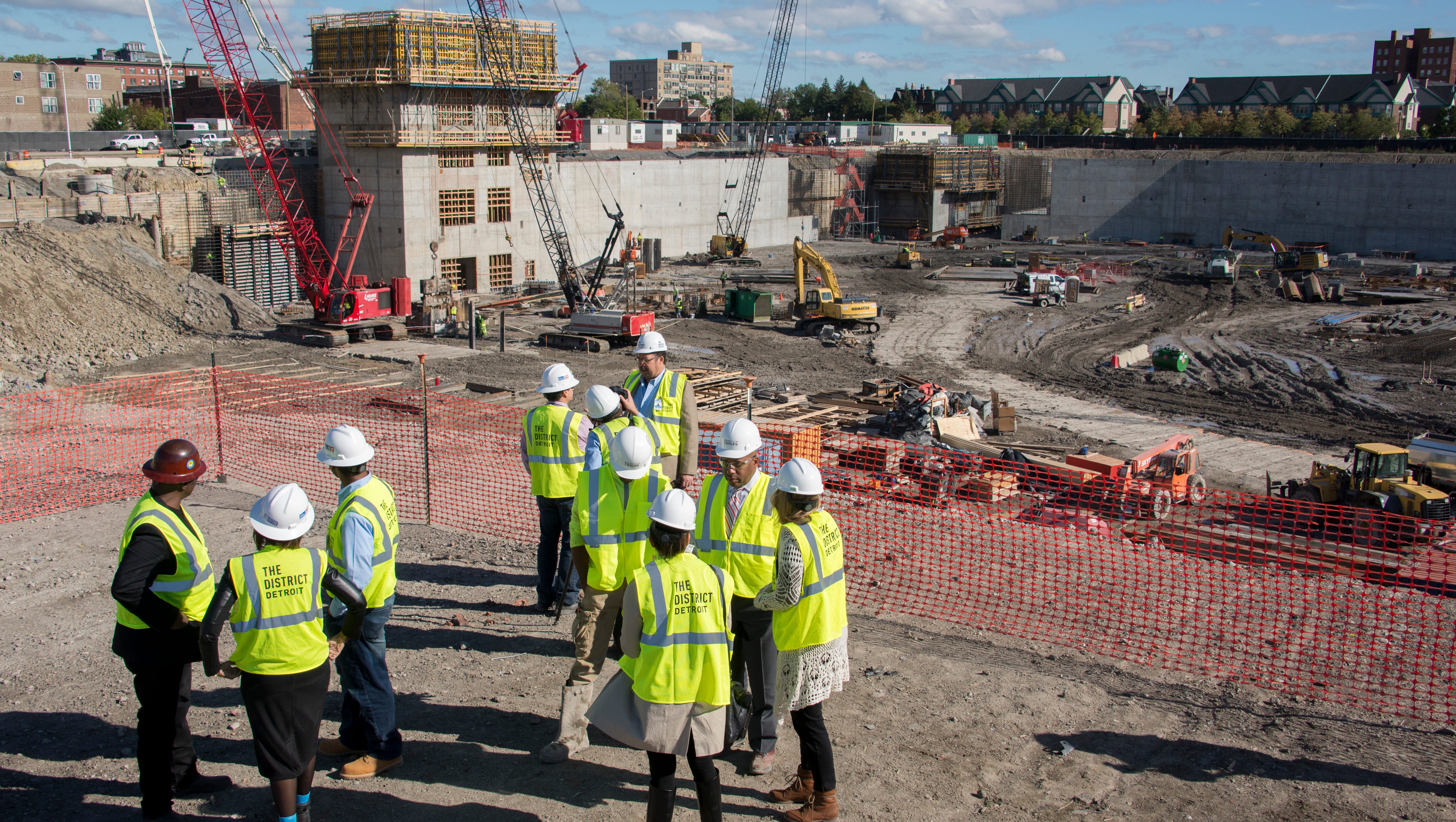 Project leaders and members of the media take in the view of the construction site      October 1, 2015.