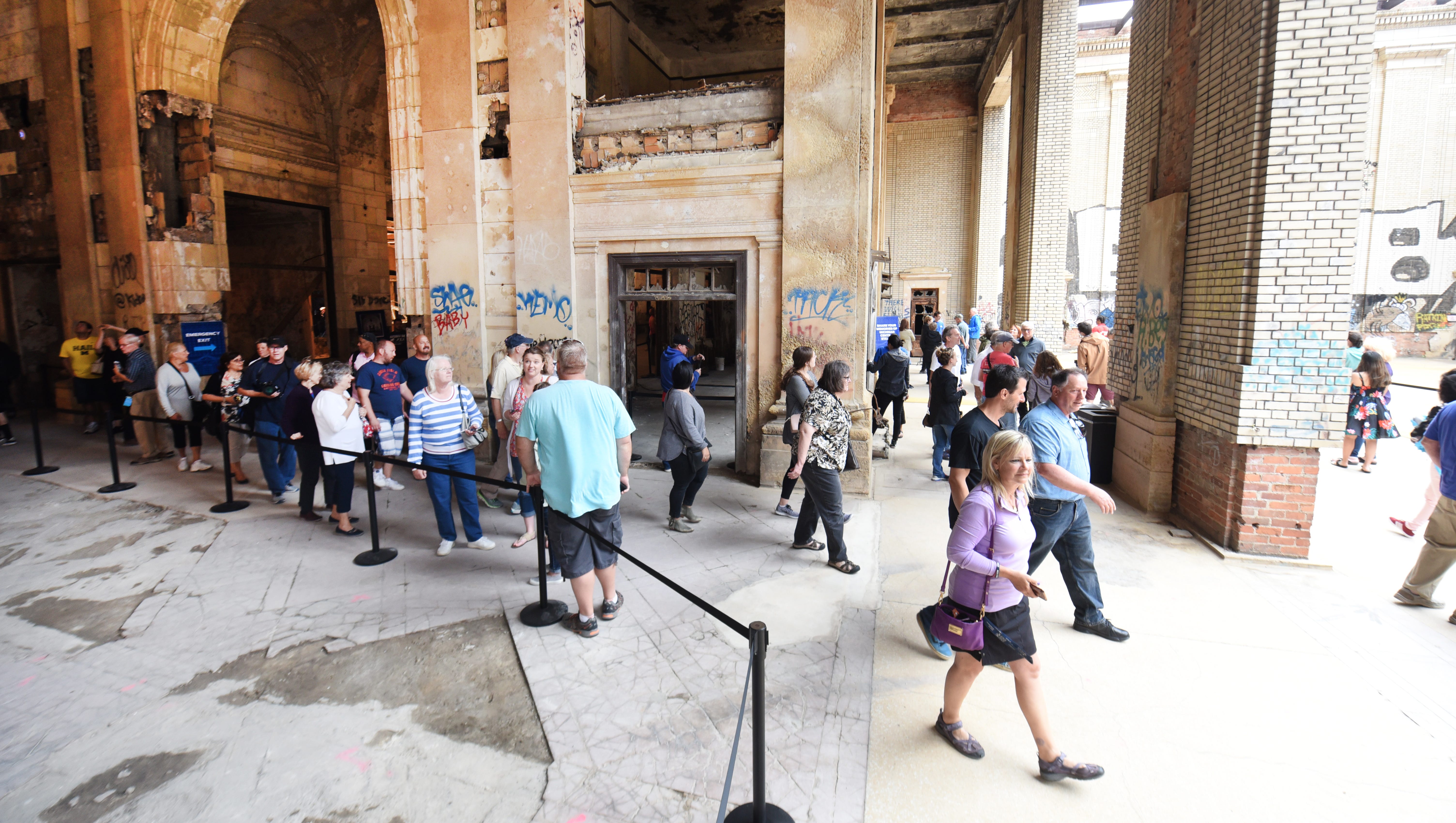 People walk through Michigan Central Train Depot as Ford Motor Company hosts a tour of the station during an open house.