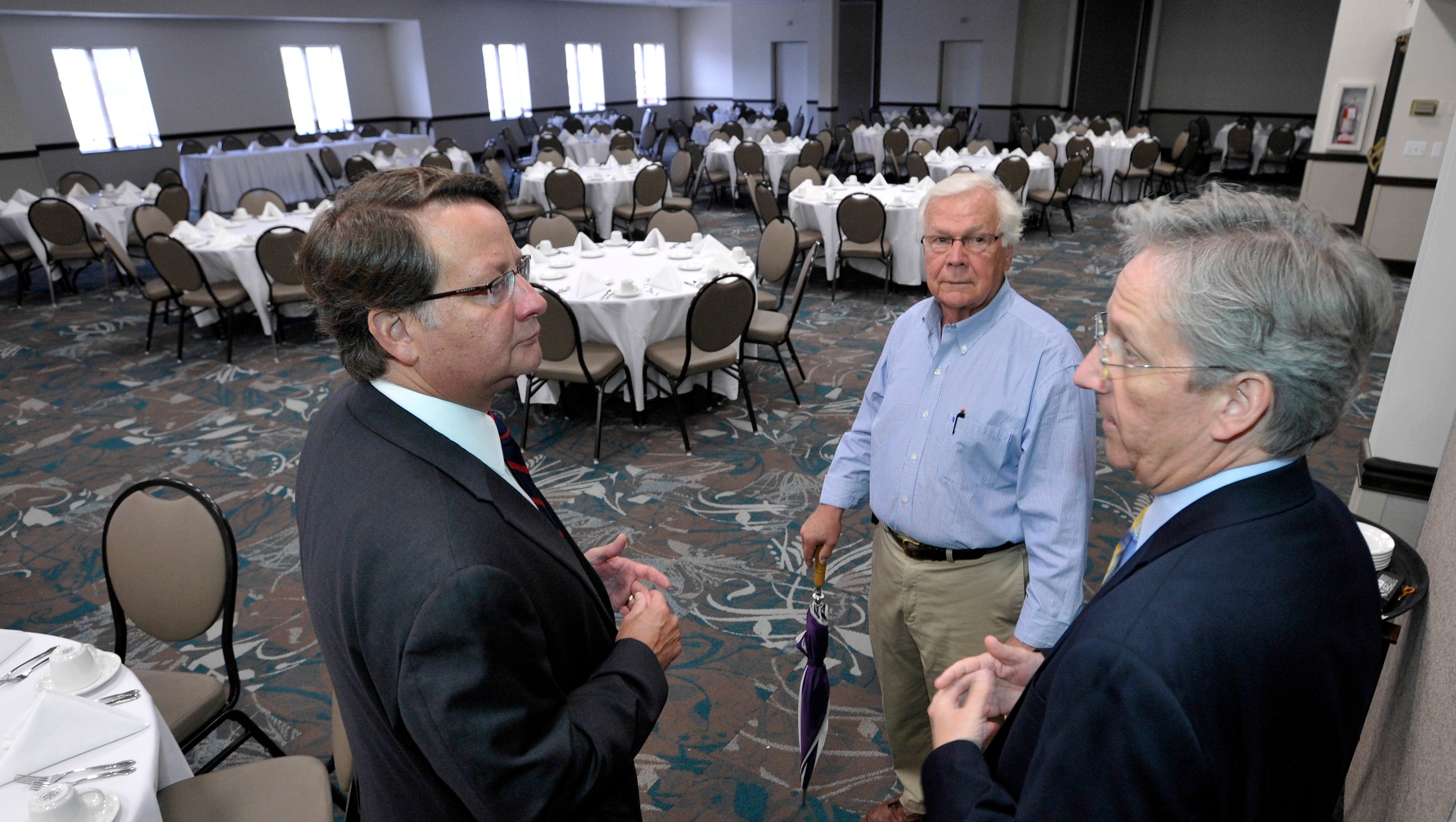 U.S. Congressman Gary Peters, left, talks with St. Clair County Commissioner Howard Heidemann, center, and St. Clair County Administrator / Controller Bill Kauffman, right, in the convention center ball room.