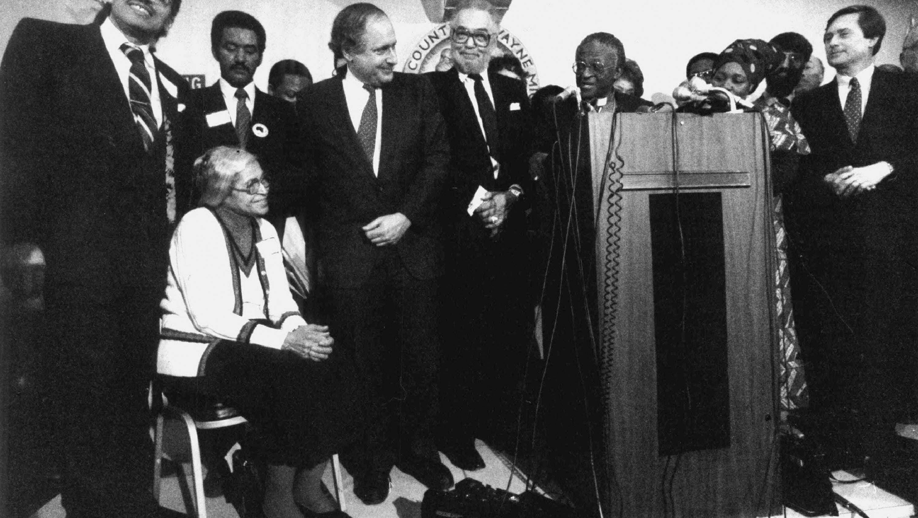 Sen. Cart Levin, center left, is among the dignitaries,  including Detroit Mayor Coleman Young, Bishop Desmond Tutu of South Africa and  Gov. James Blanchard  at an event honoring  civil rights pioneer Rosa Parks, seated,  in Detroit in January 1986.