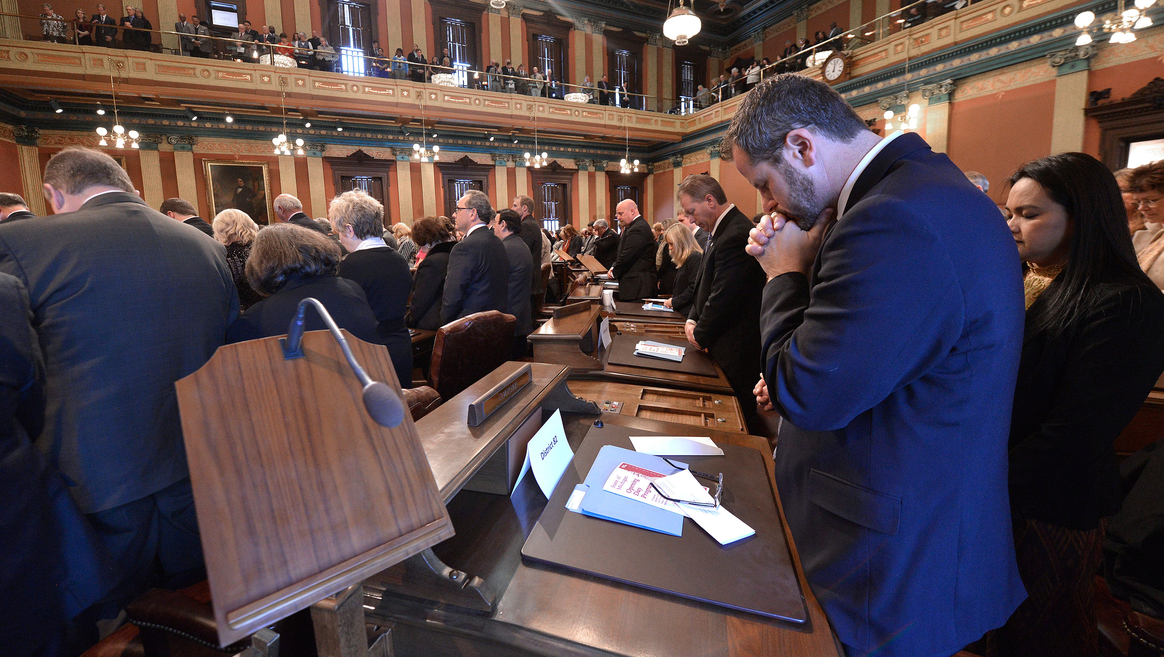 Rep. Todd Courser, R-Lapeer,  takes a quiet moment during the invocation.