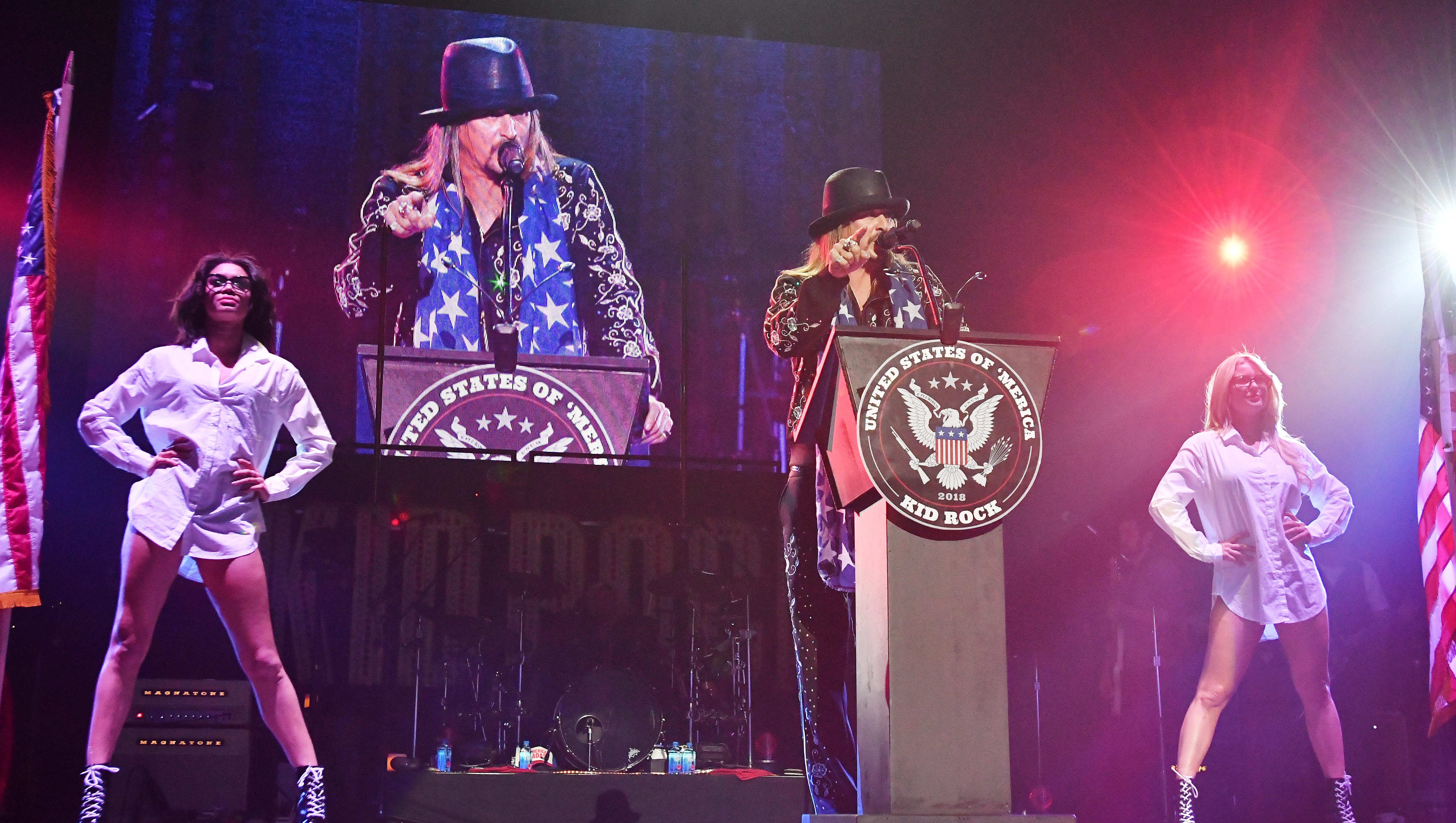 Kid Rock makes a political statement during the start of the first-ever concert at Little Caesars Arena on September 12, 2017.