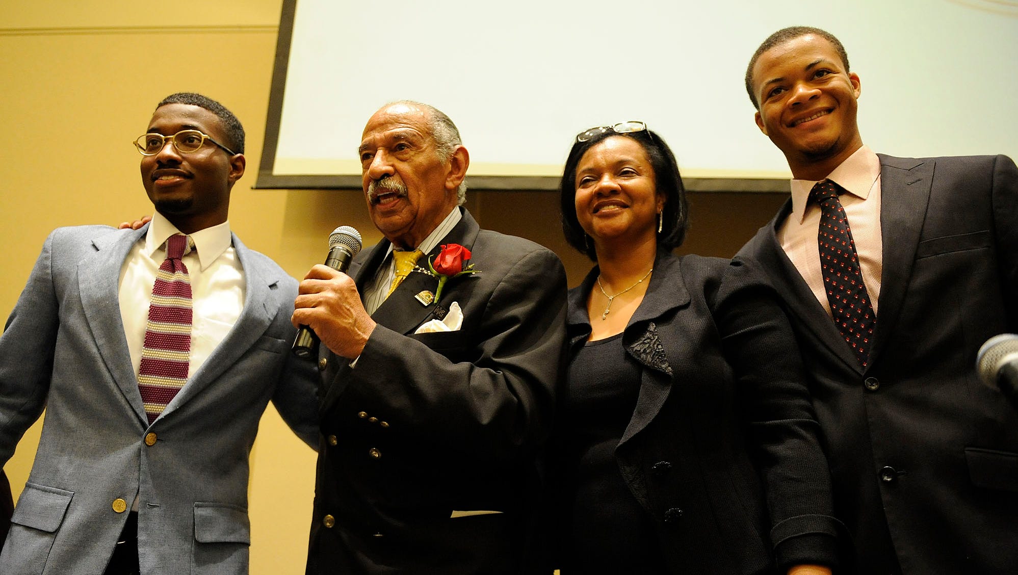 Conyers addresses attendees at a gala and fundraiser in his honor at Greater Grace Temple Church in Detroit, with sons John III and Carl Edward and wife, Monica, on Sunday, Sept. 29, 2013. Political colleagues, civil rights leaders and hundreds of constituents gathered to pay tribute to the then-second-longest-serving member of Congress.