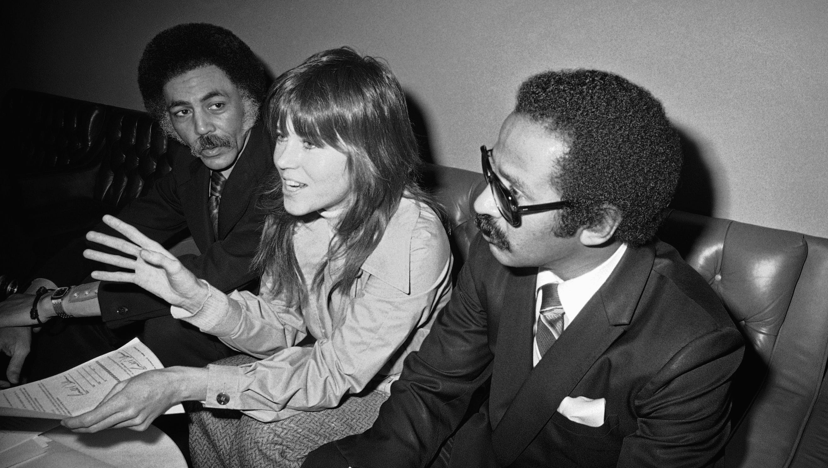 Conyers, right, and Rep. Ronald Dellums, D-Calif., flank antiwar activist Jane Fonda as she answers questions about her Vietnam protest on Capitol Hill on Jan. 28, 1974.