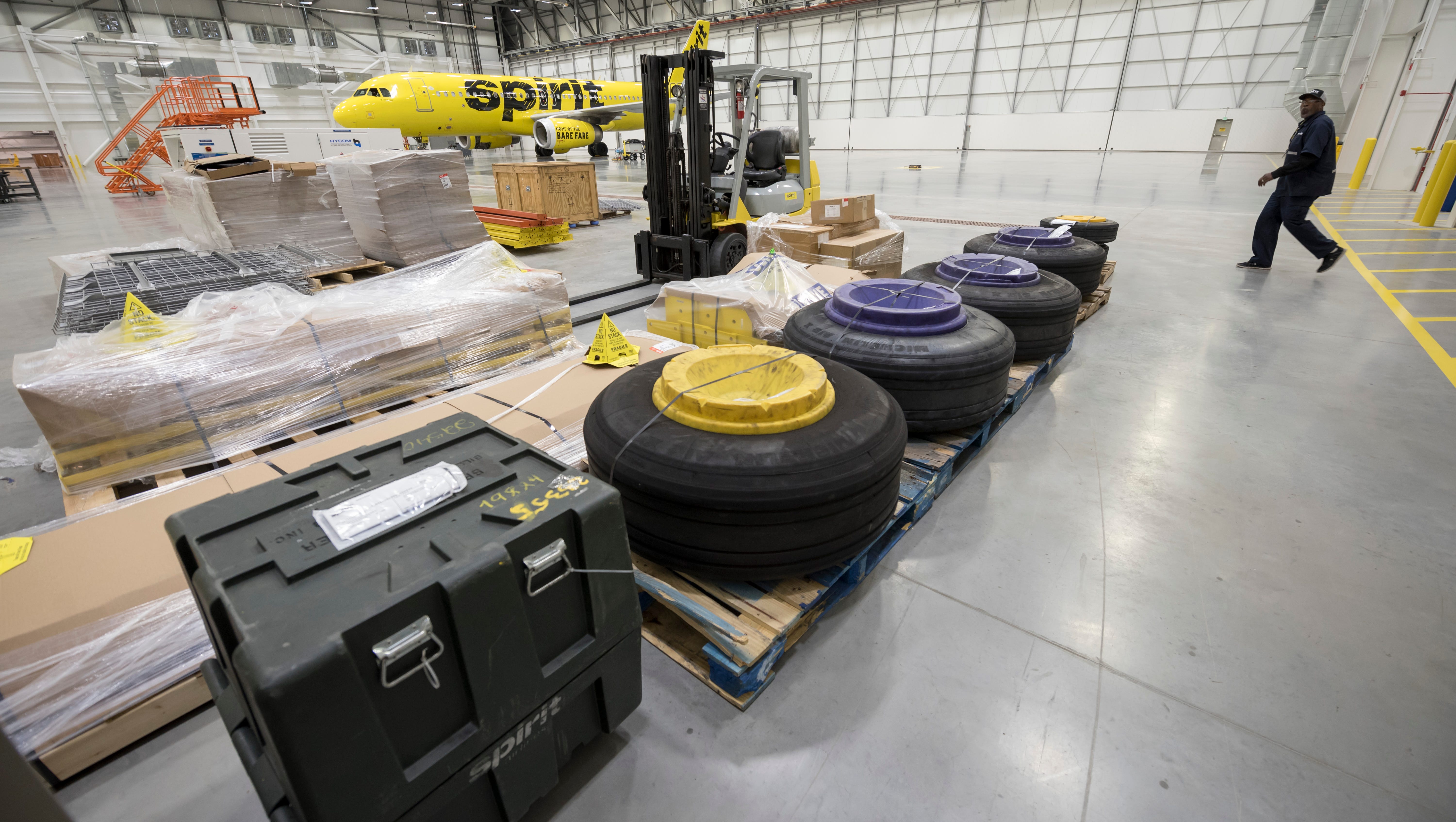 Tires that have been removed from airplanes along with other parts are stored in the main hangar bay.