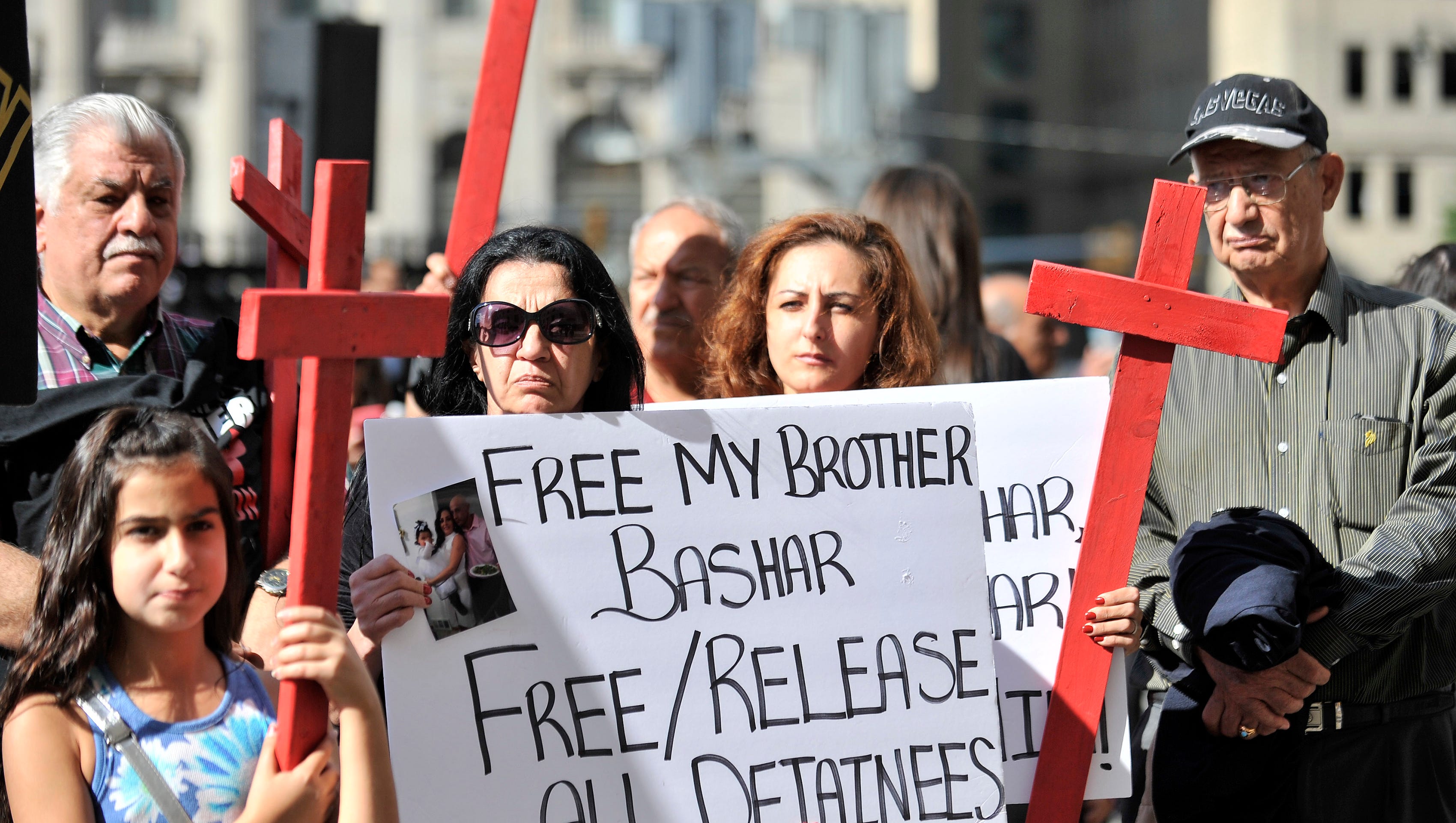 Ghada Babbie of Farmington Hills, wearing sunglasses, and her sister-in-law, Sonya Babbie, of Warren demonstrate for relative Bashar Babbie at a rally outside federal court Thursday in Detroit in support of Iraqis detained by Immigration and Customs Enforcement.