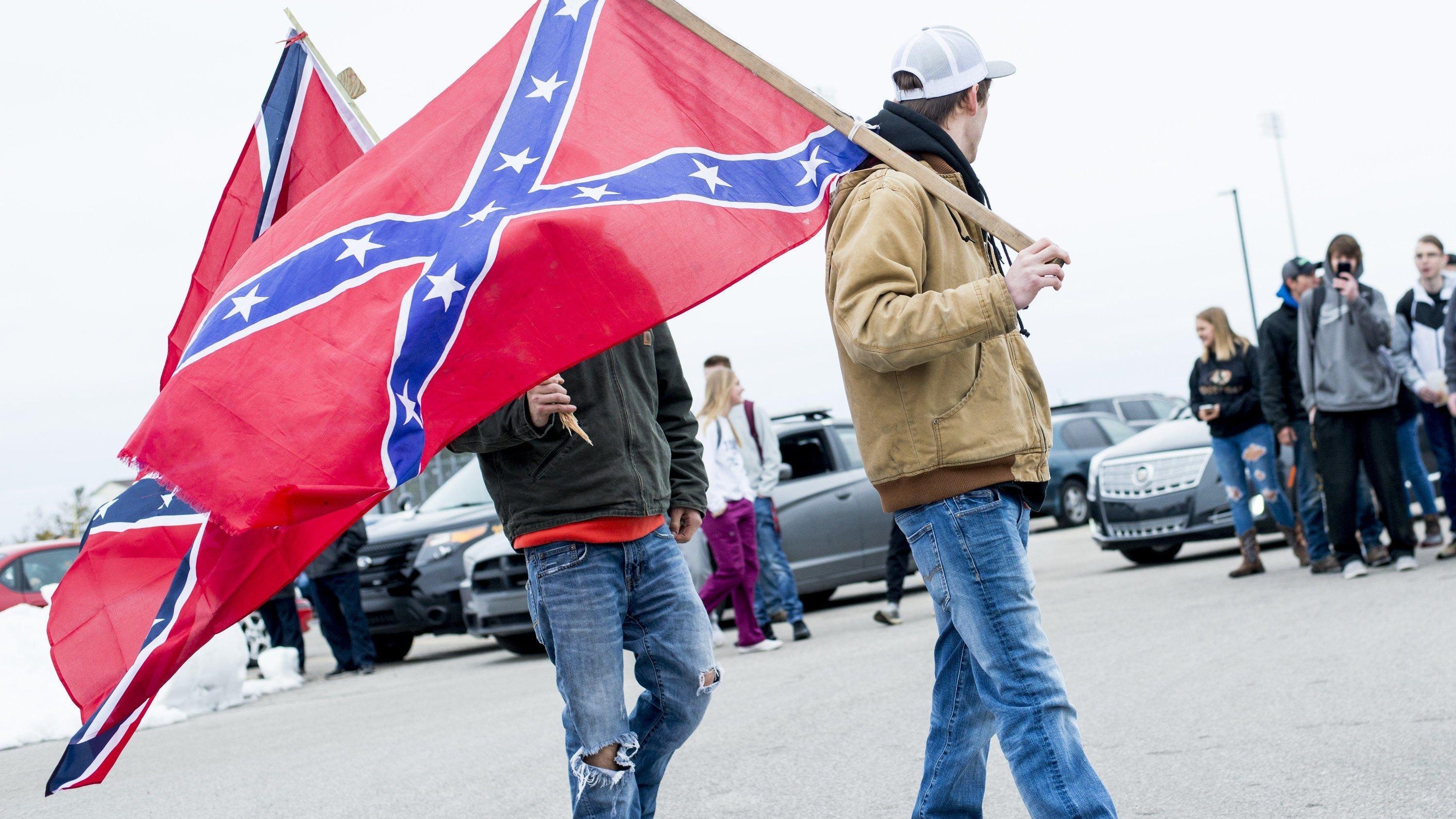 Students demonstrate in support of a Bay City Western High School student, who claims his Confederate flag was torn from his truck last week, Wednesday, April 18 2018, in Auburn, Mich.