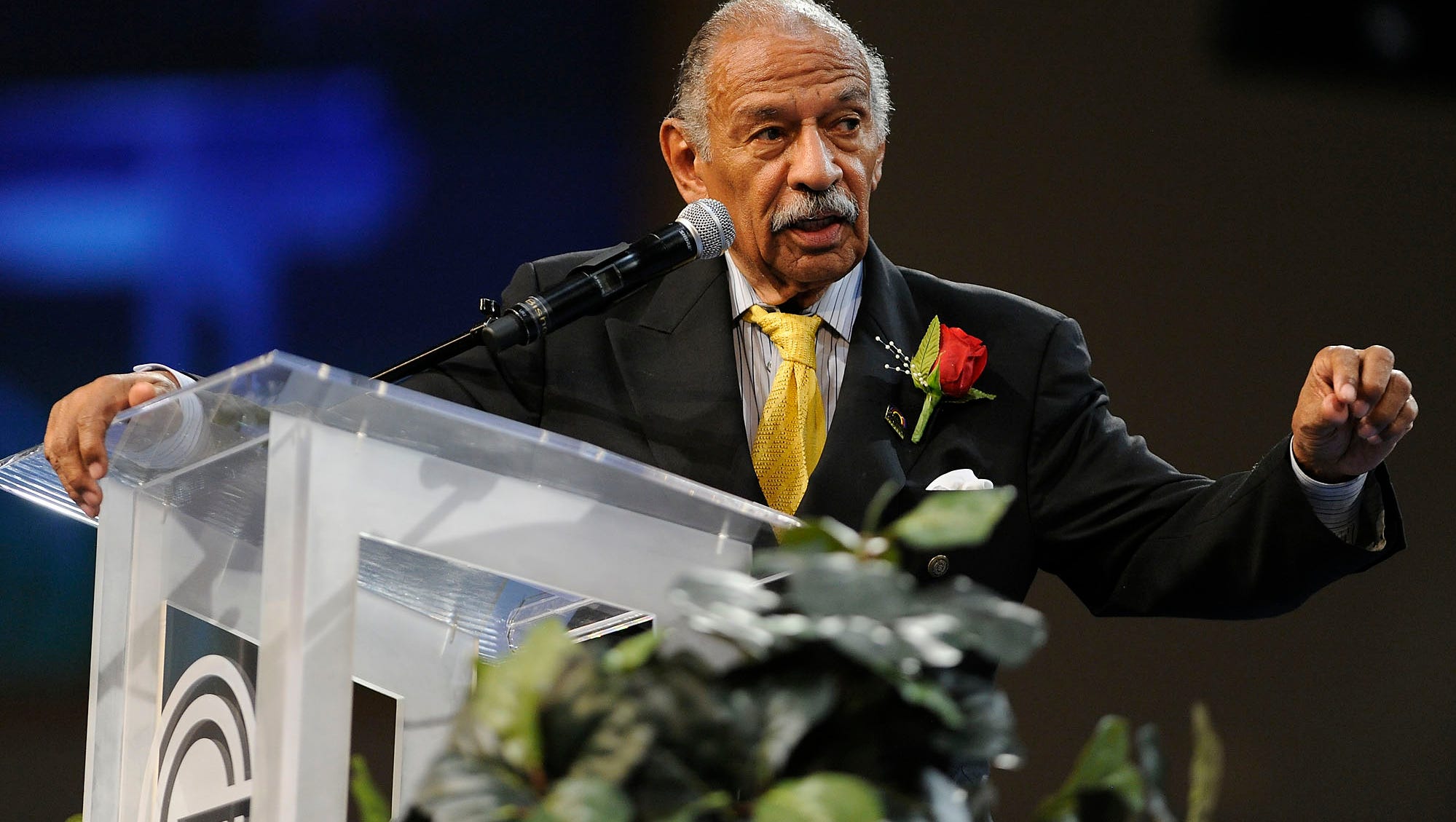 Conyers addresses attendees of his 2013 tribute at Greater Grace Temple Church about taking the message of his legacy — jobs, justice and peace — further. By this time, after the 2012 redistricting, Conyers was representing Michigan's 13th District, comprised of parts of Detroit and its suburbs.