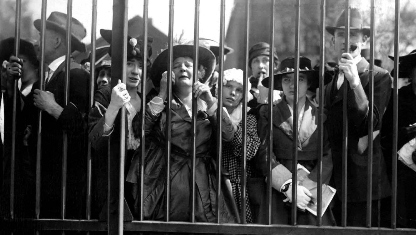 A mother cries at the train shed gates as she and others watch men head off to the first World War.