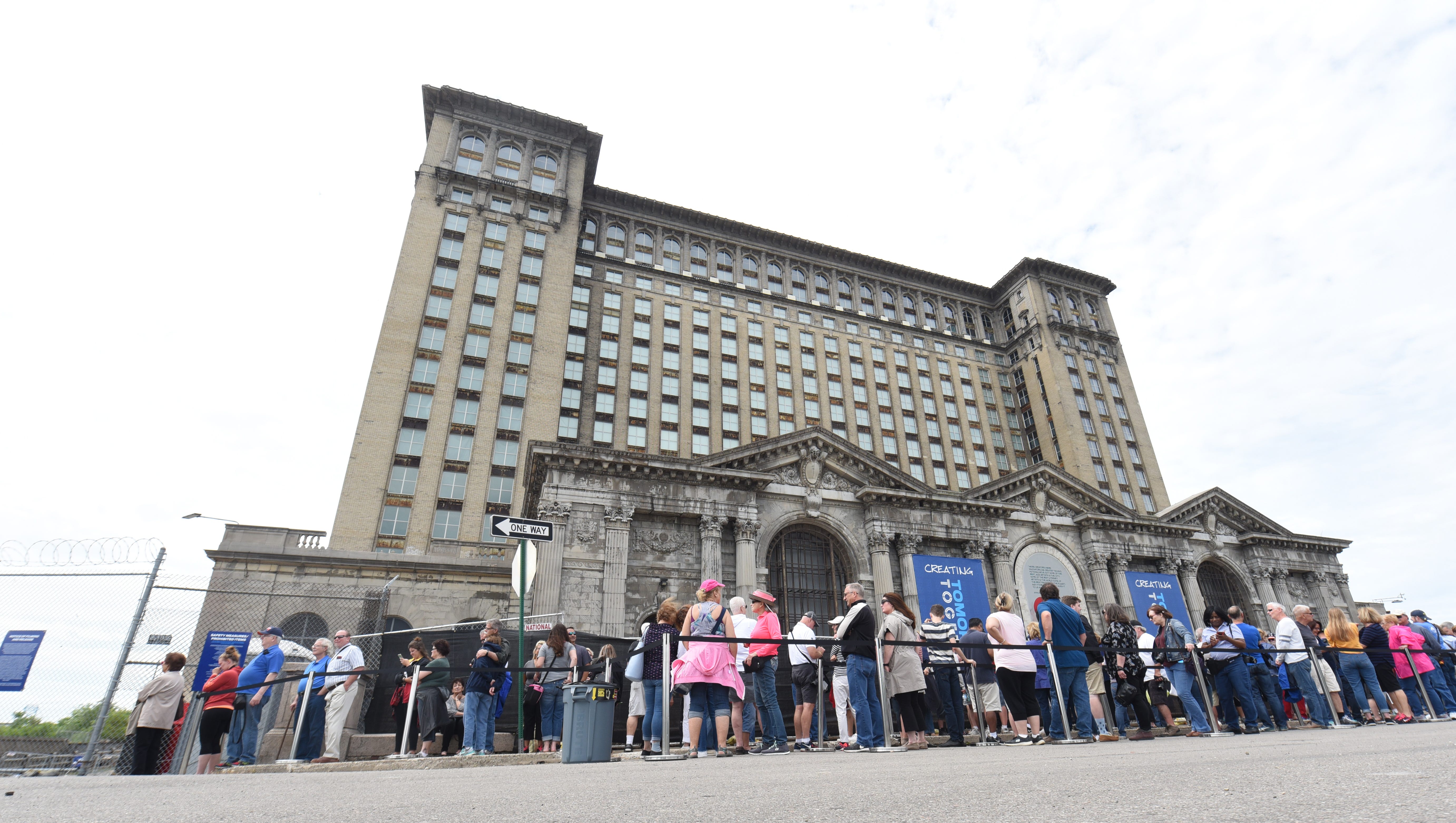 Hundreds of people wait in line outside the Michigan tours of the station during an open house on Friday, June 22, 2108 in Detroit.