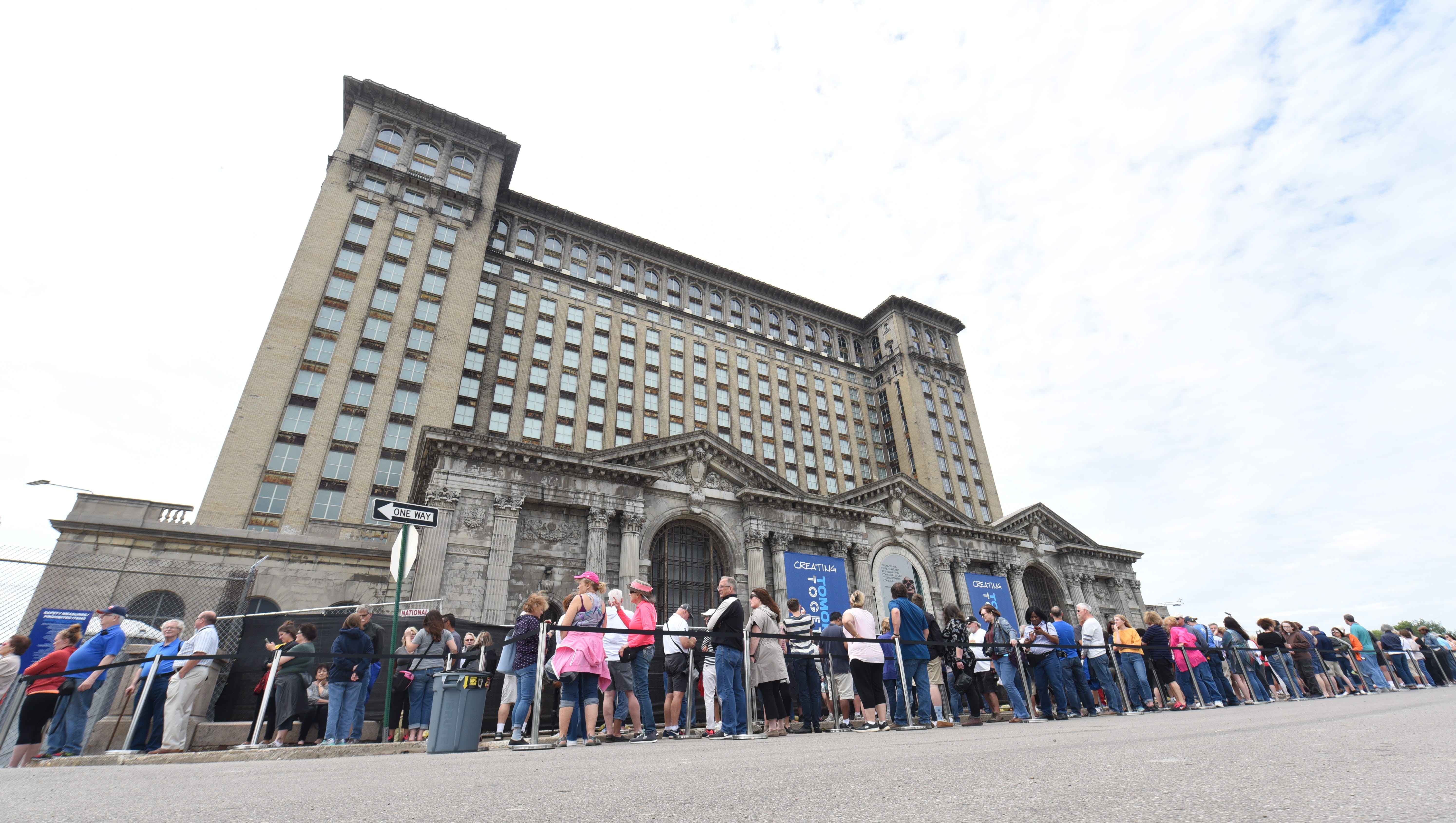 Hundreds of people wait in line outside the Michigan Central Train Depot as Ford Motor Company hosts an open house at the Detroit landmark on Friday, June 22, 2018..