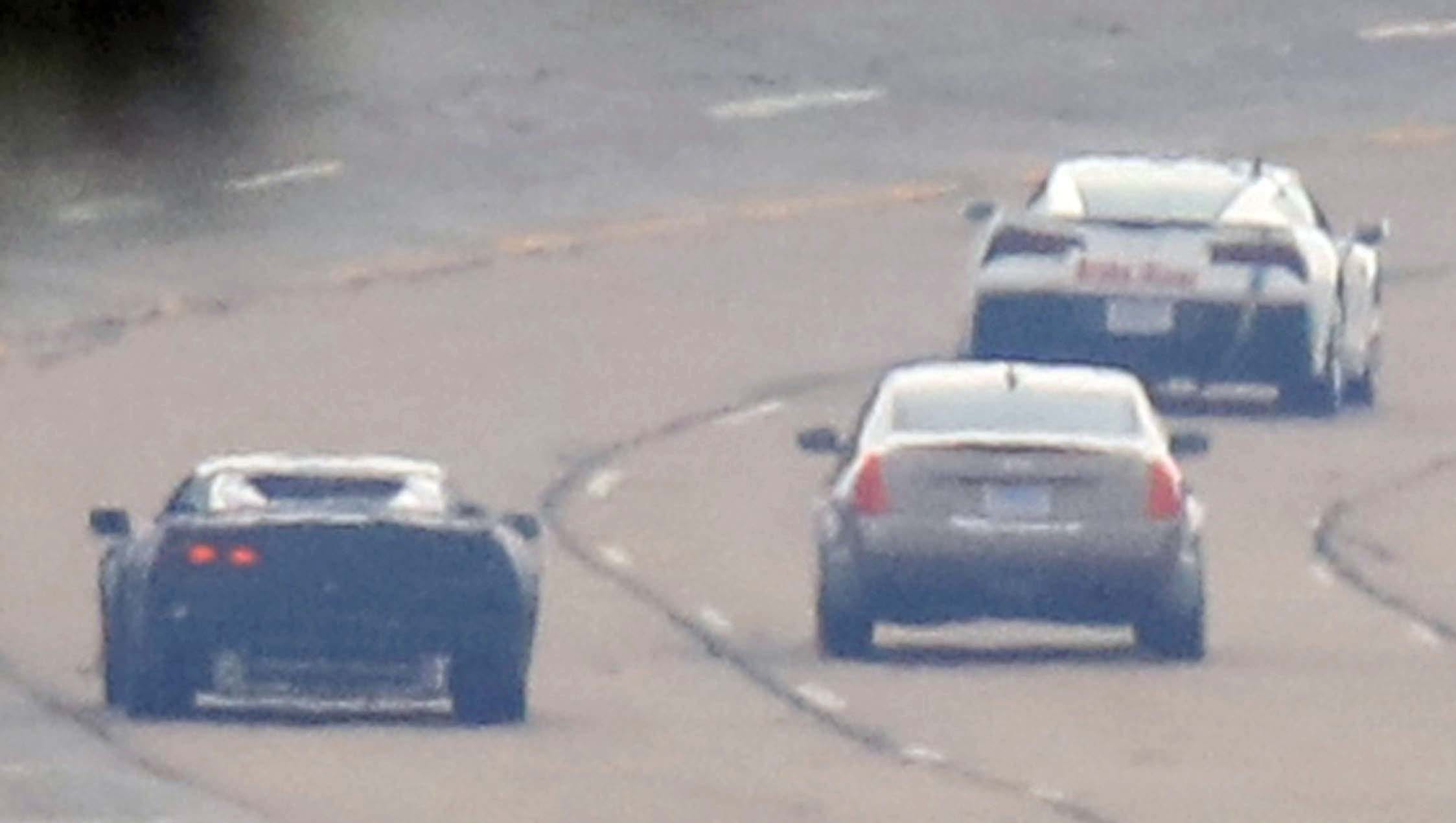 In this spy shot taken in June, 2016 at GM's Milford Proving Grounds, the mid-engined Corvette C8 test "mule" (left) runs with a Cadilllac sedan (middle) and current Corvette C7.