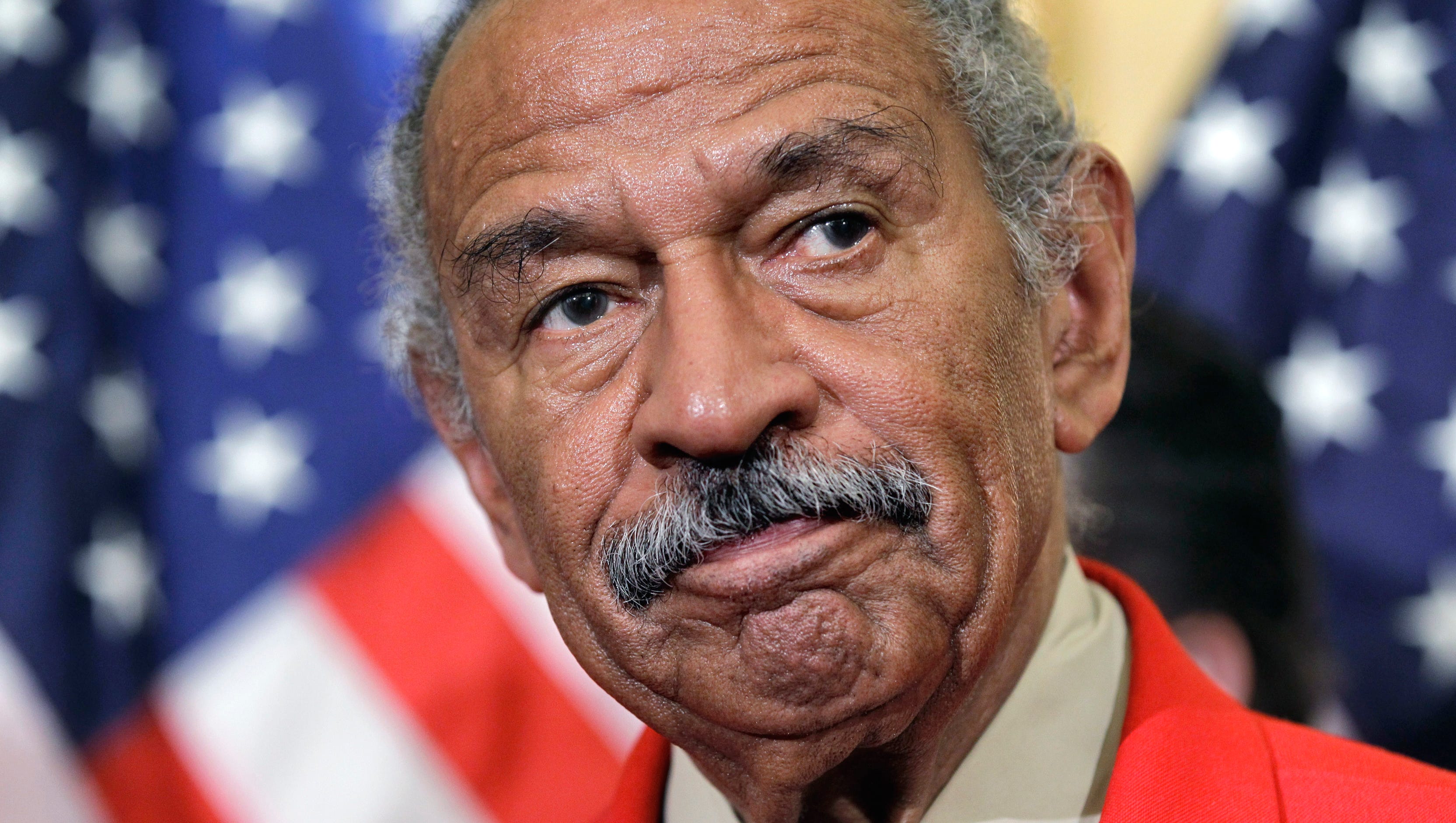 Conyers listens during a news conference on Capitol Hill in 2011 to discuss efforts to thwart the harm done to the economy by online vendors dealing in counterfeit goods or copyright infringement.