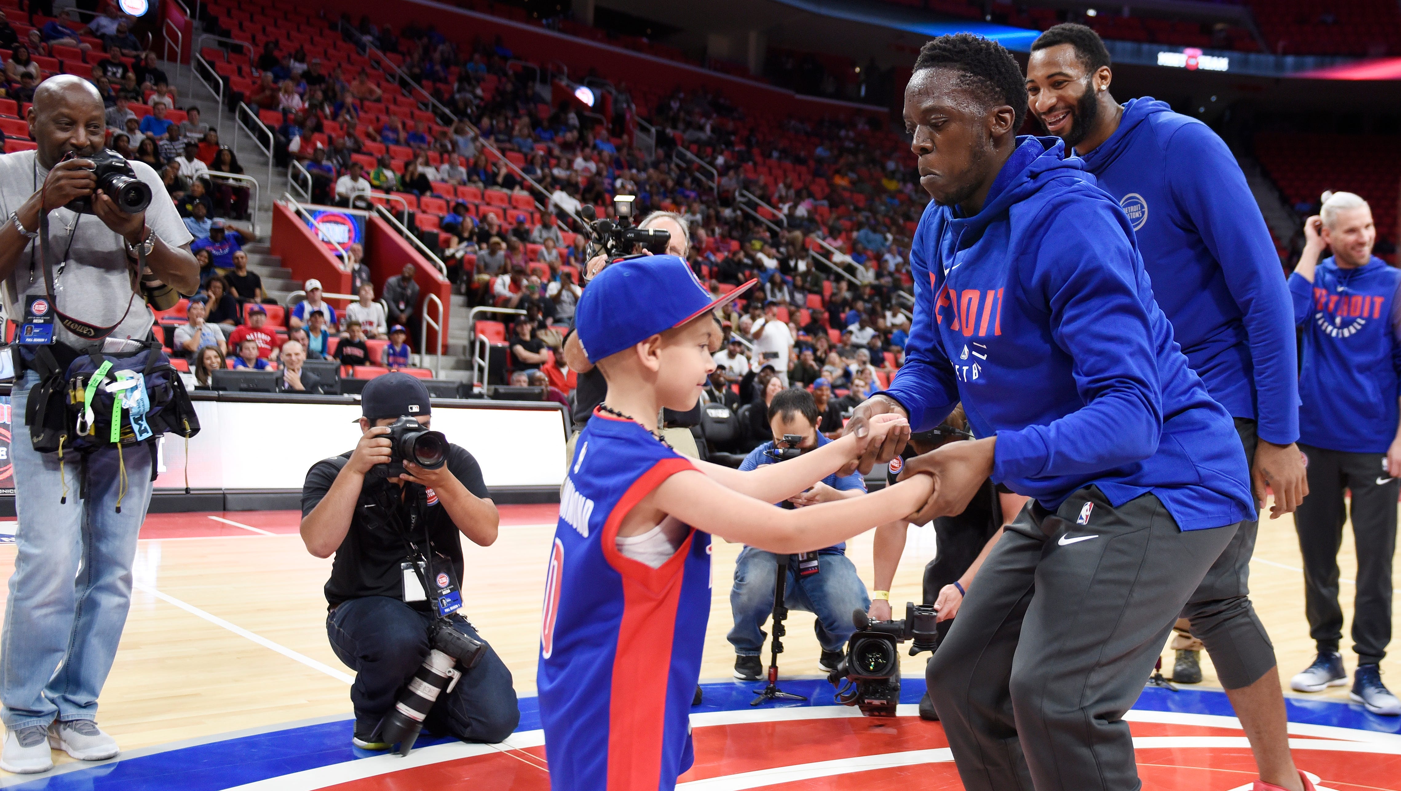 Pistons' Reggie Jackson dances with 6-year-old Zack Jaafar of Dearborn Heights at the Pistons Meet the Team event.